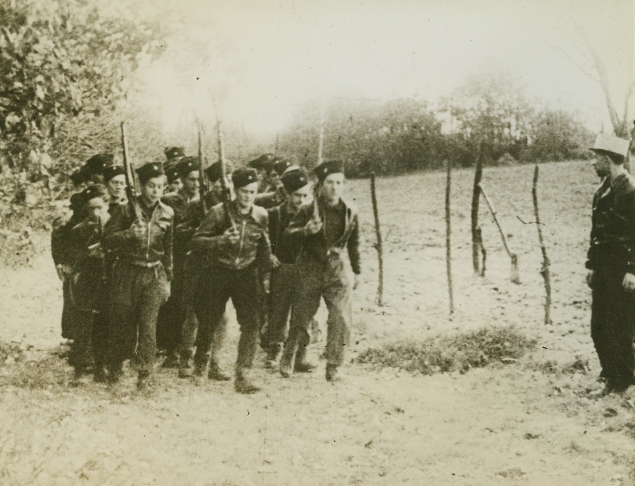 First Photos of French Underground, 3/13/1944. This photo, smuggled out of France and which just reached the U.S., is from a movie film made at one of the secret bases of the Maquis—French guerillas of the Underground who are fighting in the Savoy mountain regions. This is one of the first photos ever to reach the U.S. of the routine life of the guerillas before Darnand, the Himmler of France, launched his main attack on them early last February. These Maquis have forced the Germans to keep 6,000 troops in the Haute Savoie district, and are laying a solid foundation of offensive aid for the coming Allied invasion. Here, former cavalrymen drill on foot at a Maquis base. For security reasons, and to make food supplies easier, patriots are divided into small groups. Credit: ACME;