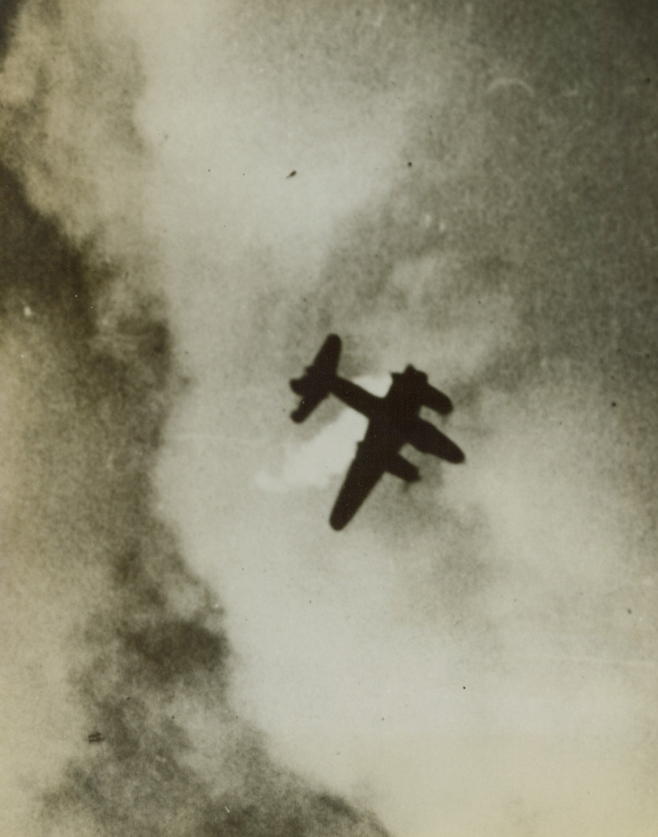 Mission Completed, 3/9/1944. Somewhere in France – Its wing shorn off by enemy flak, a B-26 Marauder goes down in flames after completing its bombing mission over military targets in the Pas de Calais area of France. The Ninth Air Force medium bomber streaked through a heavy curtain of flak to complete its job. Credit: ACME;
