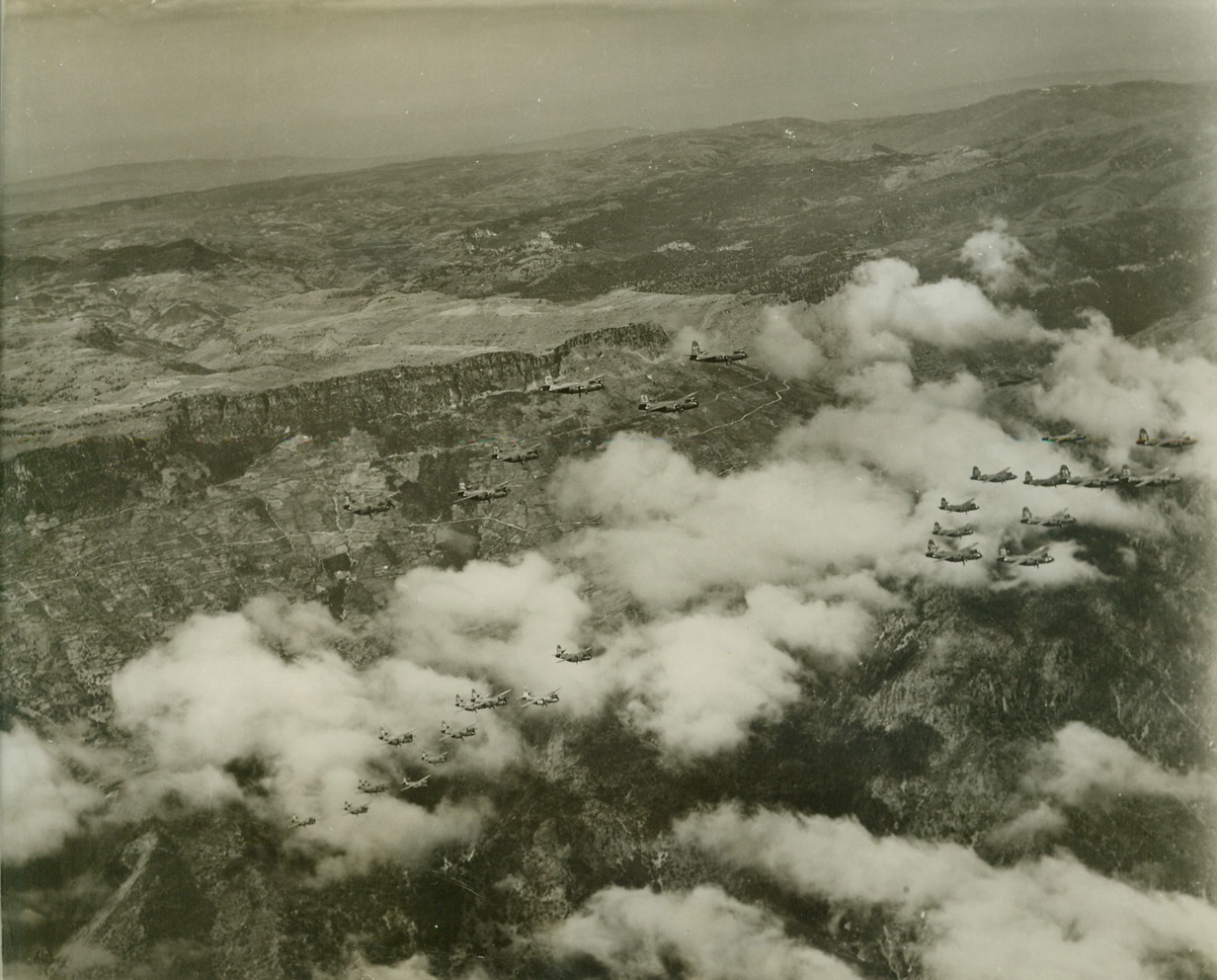 Air “Squeeze Play” on Axis, 4/24/1944. Sardinia – Hitler’s “Festung Europa” today, is being shattered and rocked by the greatest concentration of aerial might the world has ever seen. Day after day, in mounting numbers and with ever-increasing ferocity, huge masses of Allied bombers and fighters are blasting German war plants, communications, and airfields into crumbling and smoking ruin in preparation for “D-Day” – and Allied invasion. These aerial armadas have occupied Europe in a gigantic pincers, with one “leg” in England, and the other in Italy and Sardinia. This series of photos shows U.S. B-26 Marauders taking off and operating from Allied fields in Sardinia, against the Southern Coast of France. Their target was the Var River railroad bridge near Nice. ---Here, the Marauders approach their target in tight, compact groups. Credit: (ACME Photo by Charles Seawood for the War Picture Pool);