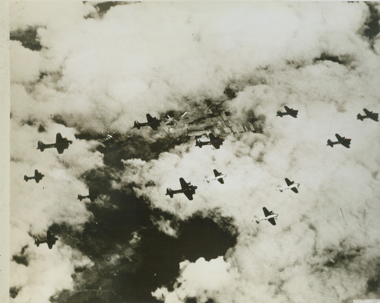 Newcomers Join the Vets, 4/12/1944. Three new Flying Fortresses, their silver sides flashing in the sun, (lower-right), thunder along with their olive-drab-painted formation mates, headed for another historic "obliteration attack" on Berlin. Camouflage paint has been eliminated from new Fortresses saving some 50 to 100 pounds in weight and adding 5 to 10 miles per hour.  Credit: (U.S.A.A.F. Photo from ACME);