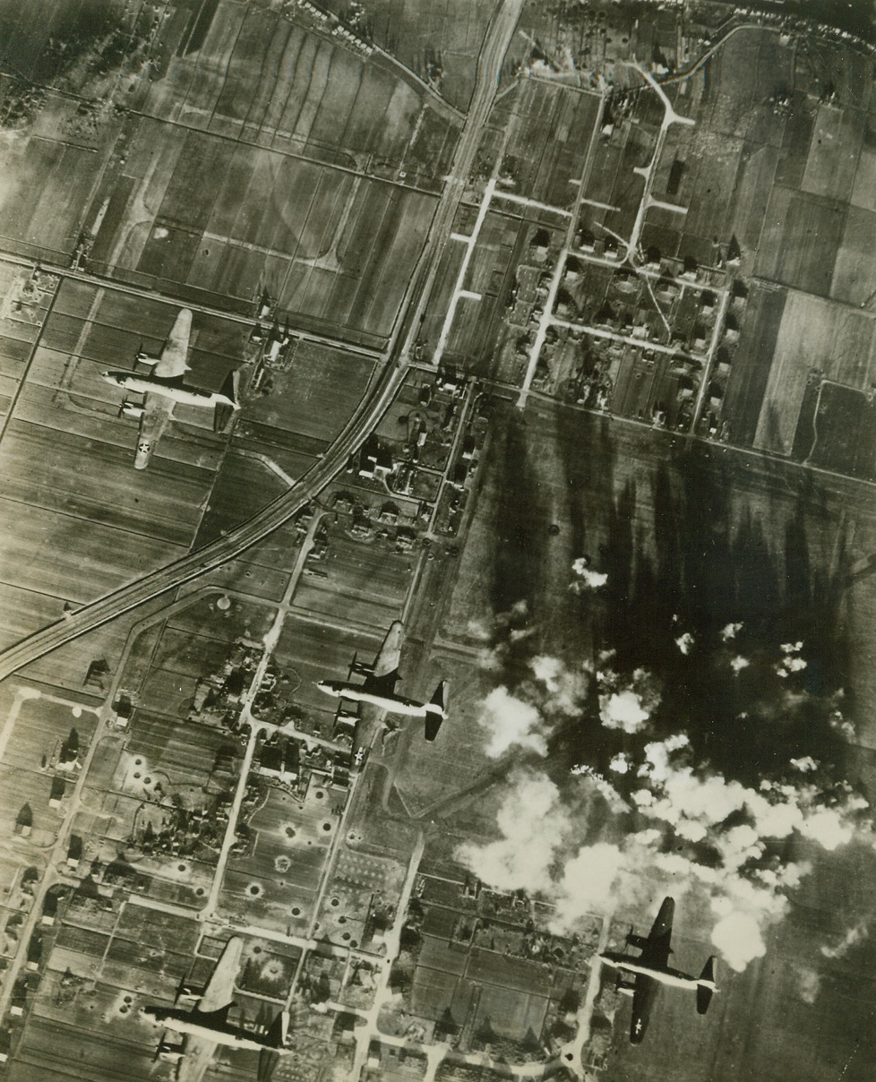 Blast Nazi Airdrome, 4/21/1944. HOLLAND – Marauder bombers (B-26) of the U.S. Army 9th Air Force head for home as their bombs explode on the Nazi-held Schipol Airdrome at Amsterdam, Holland. One of the largest and heavily defended airfields in Europe our air force has successfully attacked it many times.USAAF Photo from Acme;