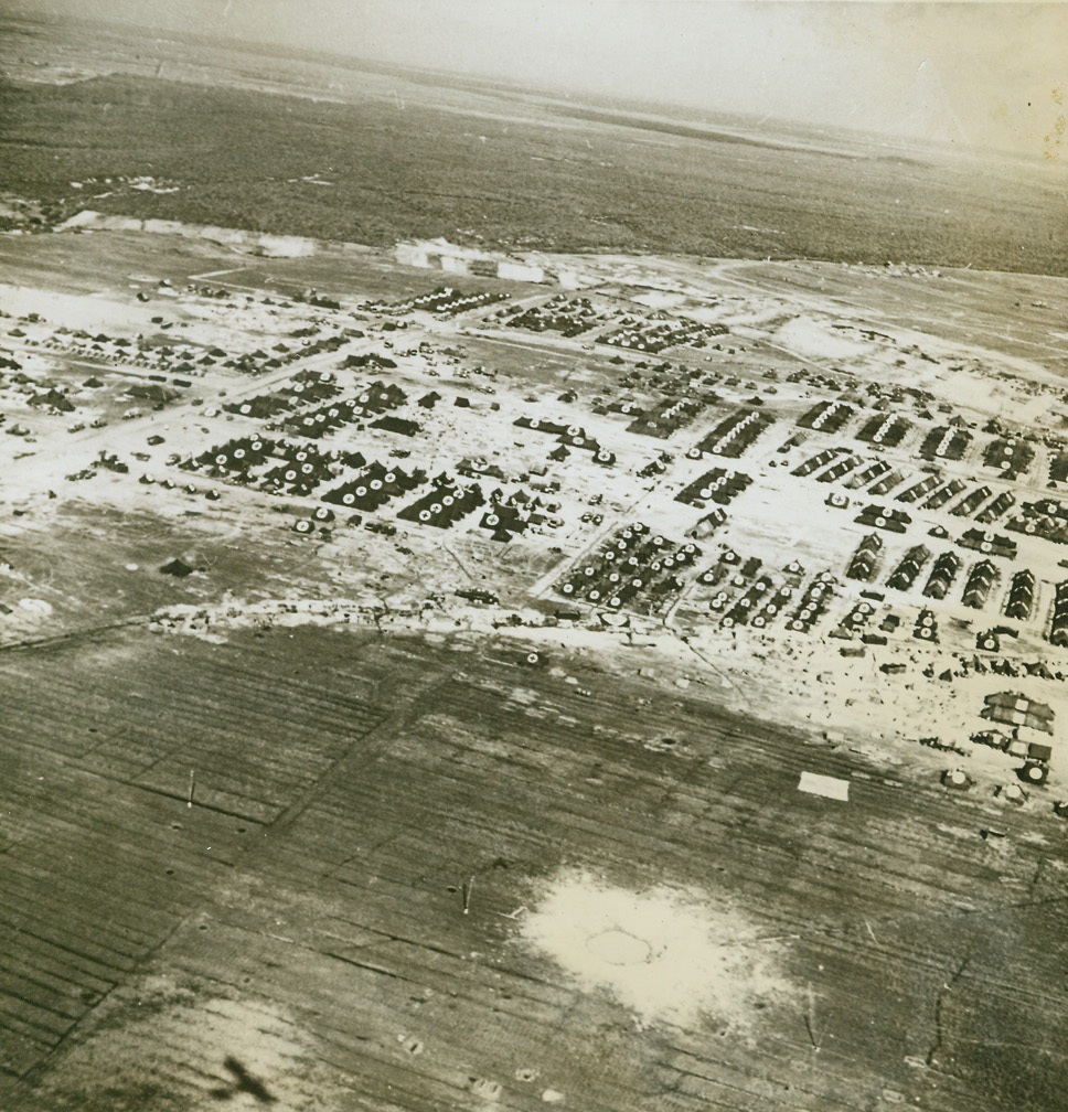 A Narrow Escape, 4/22/1944. ANZIO, ITALY – A few yards more and the bomb which dug this huge crater in the foreground would have landed right on the International Red Cross sign designating a hospital area. Although each tent is clearly marked with the Red Cross, the area has been shelled, strafed, and bombed by the enemy. Credit (Acme) (WP);