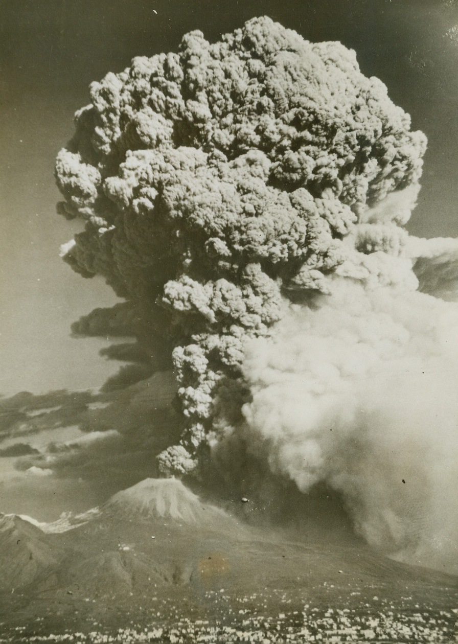 Mt. Vesuvius Erupts Its Terror, 4/8/1944. NAPLES, ITALY – Gigantic cloud of smoke swells in ascendancy, like some huge jinni, from the Aladdin’s lamp that is Mt. Vesuvius. The city of Naples rests in the foreground. Credit Line (Acme);