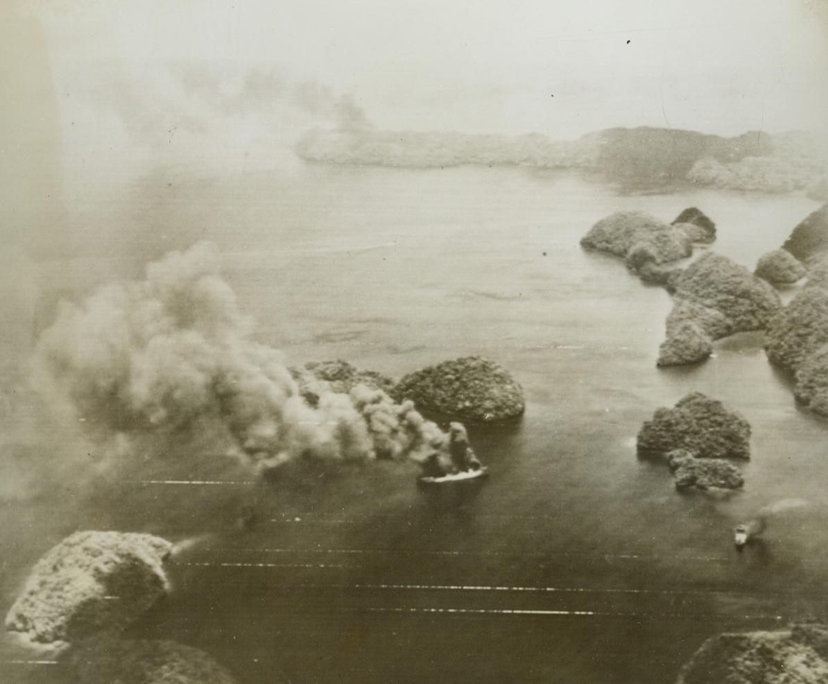Yanks Blast Japs at Palau, 4/11/1944. This photo, flashed to the U.S. by Radiotelephoto, shows three Jap ships burning at Palau, (At top, center; lower center; and lower right) during the three-day attack by a huge armada of U. S. Pacific Fleet units on Palau, Yap, Woleai, and Ulithi Islands. In the attack—the greatest American Naval victory since Midway—46 Nip ships were sunk or damaged and 214 enemy planes destroyed. Credit: U.S. Army Radiotelephoto from Acme;