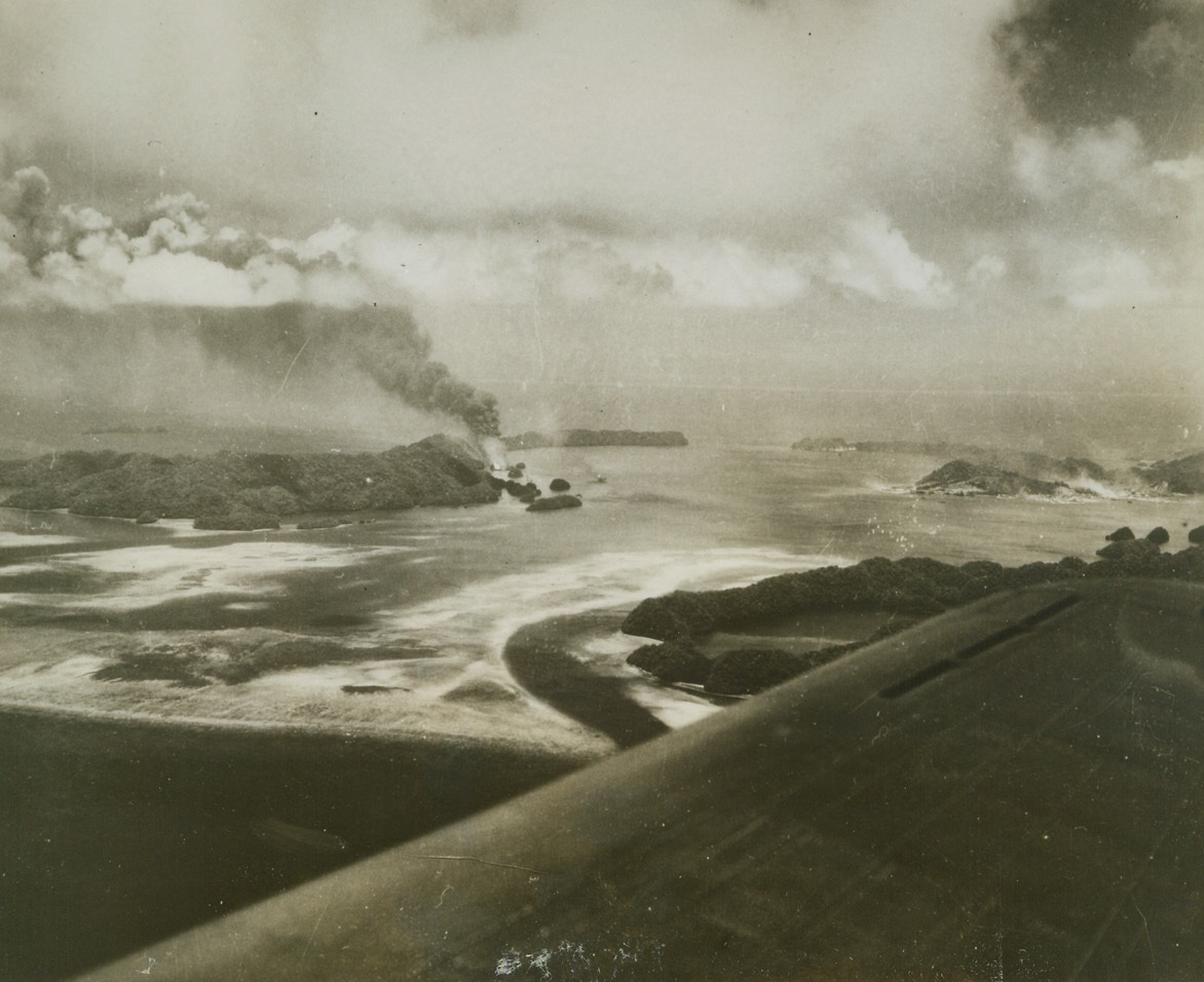 Yank Task Force Raids Palau, 4/15/1944. Palau – Smoke rises from fires burning all over Palau Islands as the most powerful task force ever to operate in the Central Pacific strikes a blow at the strategic Jap base, only 600 miles from the Philippines.  Unchallenged by the wreaked havoc on Palau and adjacent enemy bases for three days at the end of March, sinking 28 ships and damaging 18, destroying 160 Jap planes and probably ruining 54 others.  Only 25 of the hundreds of American planes in the force were lost.Credit Line -WP-(ACME);