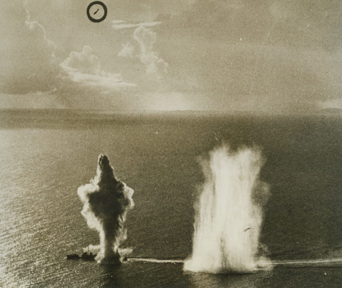 Bomber – and “Bombee”, 4/26/1944. Two bombs from U.S. Navy dive bombers explode on, and near a Jap destroyer, while at upper left (circle) a bomber comes out of its dive.  The Nip warship was one of 48 enemy vessels sunk or damaged in the smash a Japan’s Western Caroline island bases last March 29-30-31.  More than 200 Jap planes were destroyed in the raid on Palau, Woleai and Yap. Credit line (U.S. Navy photo from ACME);