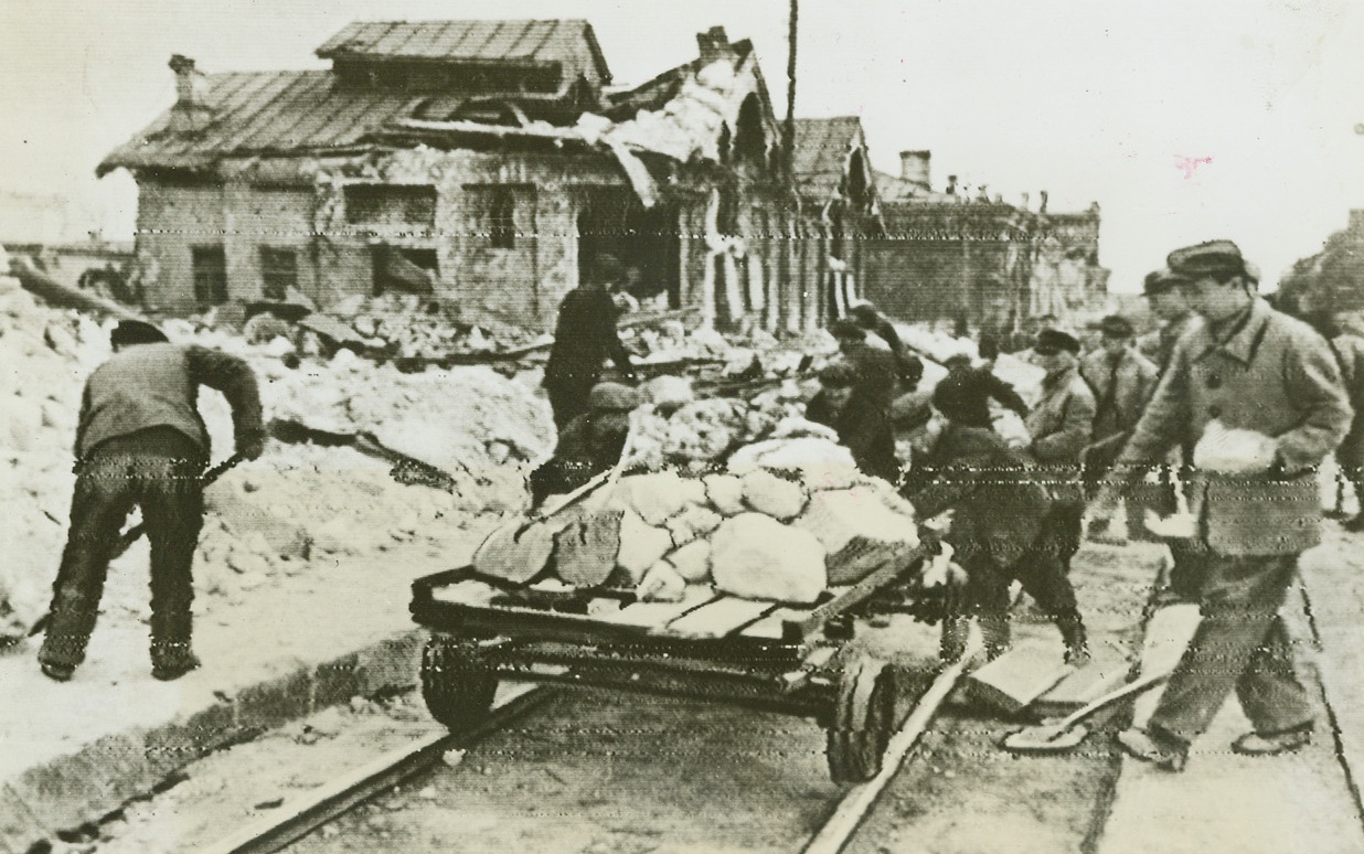 Death—At a Summer Resort, 4/26/1944.  4/26/1944. Alusha, Russia—When Red Army forces drove the Germans from this once-famous Russian summer resort, they found a scene of desolation and death. Here, abandoned German supply wagons line the curb of one of the streets of the town, while on the sidewalk are the corpses of Nazis and horses. (Passed by censors) Credit: ACME radiophoto.;