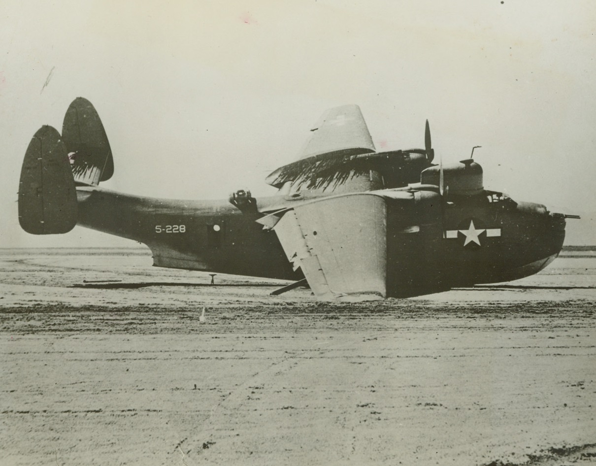 Dry Landing, 4/24/1944. Washington, D.C: When one of their two motors went dead above the wasteland of Arizona, as they were flying to the West Coast, the pilot and crew of this giant 20-ton Martin Mariner (PBM) Seaplane landed on a dry lake. Though the plane suffered minor damage, lack of facilities forced the Navy to dismantle it and ship it out piece by piece. The pilot, Lt. Scott S. Fitzgerald, USNR, of High Point, N.C., and the other six airmen have been commended for “exceptional airmanship.” 4/24/44 Credit (ACME);