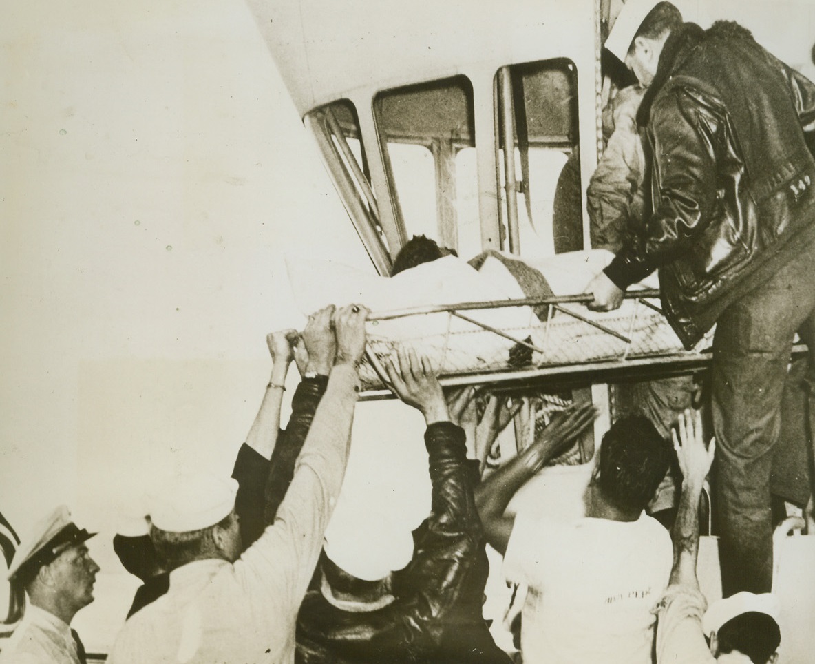 First “Sea-to-Airship” Rescue, 4/14/1944. Picked from the sea by a Navy patrol blimp in the first “sea-to-airship” rescue, Lt. Harvey Medcalf, USMC, of Minneapolis, Minnesota, is removed from the cabin of the rescue ship to be taken to a hospital, only one hour and twenty minutes after his Torpedo Bomber crashed. The blimp was guided to the scene of the crash by flares sent up from the life raft bearing Lt. Medcalf, who was badly wounded, and another pilot, who was uninjured. The rescue took place in March 1943. Credit: U.S. Navy photo from ACME;