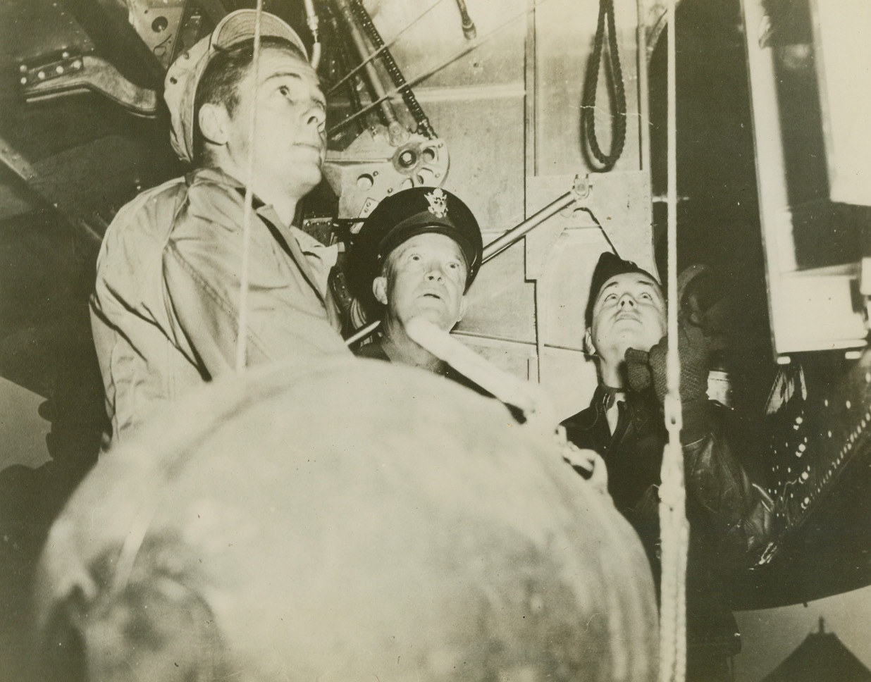 IKE WATCHES “EGG” LOADING,  4/24/1944. ENGLAND – Gen. Dwight D. Eisenhower, Chief of Allied Forces in the European theater, (center), watches a heavy bomb being hoisted into the bomb bay of a B-26 Marauder, during a recent visit to a American base “somewhere in England.” (The men with the General are not identified.)Credit: U.S.A.A.F photo from Acme;
