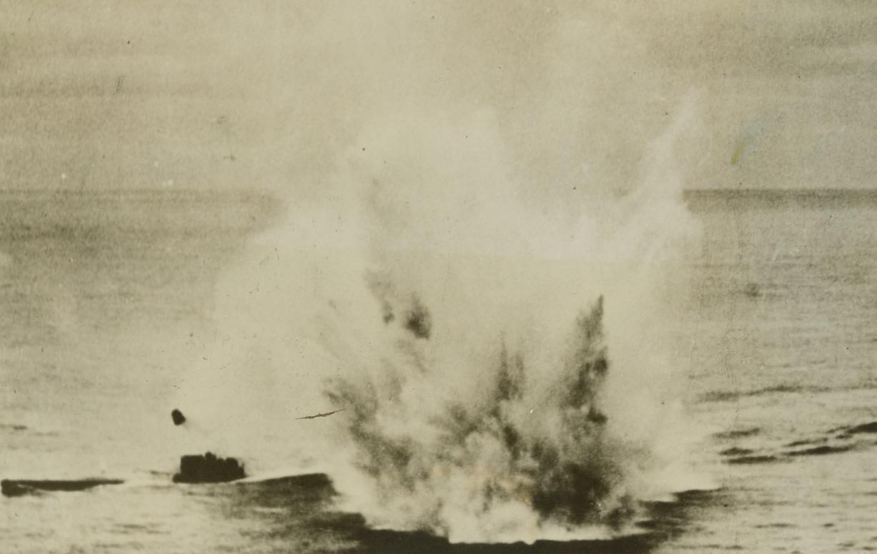 U-BOAT GETS THE “DEEP SIX”, 4/27/1944. SOMEWHERE IN THE ATLANTIC – This German undersea vulture will never pluck at Allied merchant ships or battle vessels again.  Water and a piece of metal rise skyward as a depth charge from an RCAF coastal command Sunderland flying boat strikes near the U-boat in the Atlantic.  Submarine crew took to one-man dinghies as the craft sank.Credit: Acme;