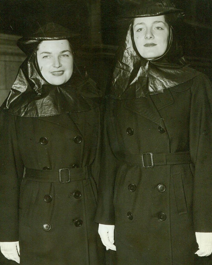 Navy Blue Is Fashionable This Year, 4/9/1944. New York—WAVEs Virginia Fielding (left) from Austin, Texas, and Rosemary Wagner, also of Austin, Texas, value their “Easter bonnets” as much as anyone, so they wear havelocks to protect them from the rain. They are leaving to St. Thomas’ Church after attending the Easter services 4/3/44 (ACME);