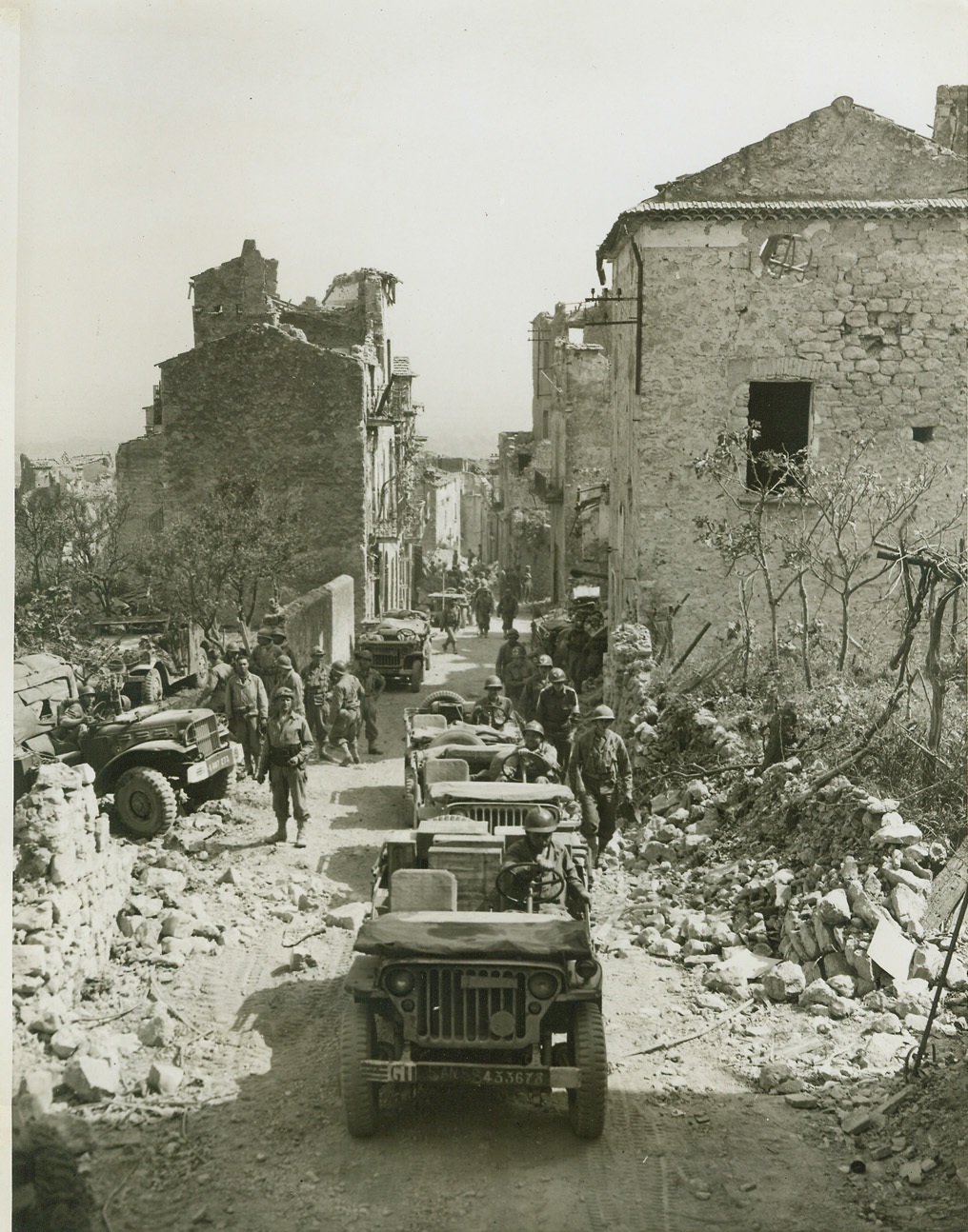 First Original Photos of Latest Italian Drive, 5/18/1944. This is one of the first original photos to be received from the Italian front since the start of the new Allied drive. The picture was made on May 13th and despite the various channels of censorship and transportation problems they were in Washington, D.C. by the afternoon of May 18th. It is believed that a new record for expediting of newspictures has thus been established by the Army. PHOTO SHOWS - French mechanized equipment as they moved into Castleforte after it fell to the combined forces of the Fifth Army during the second day of the spring offensive.;