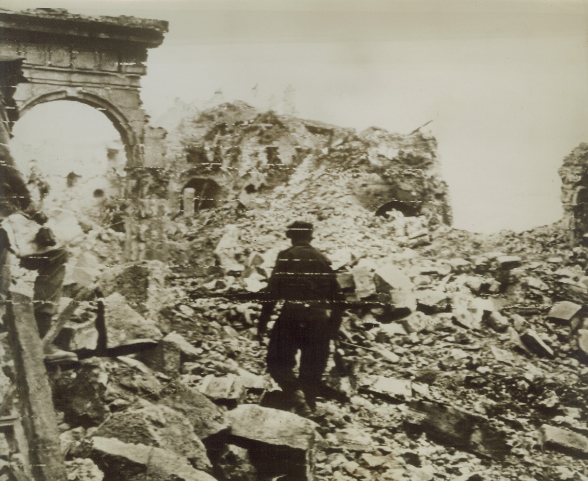 Ruins of Cassino Abbey, 5/24/1944. This photo, flashed to the U.S. by Radiotelephoto today, shows an Allied Eighth Army soldier carefully making his way through the shattered ruins of the once-beautiful Benedictine Abbey on a mountain top overlooking the city of Cassino, Italy. The Abbey were Germans emplaced heavy guns to fire on the Allies besieging Cassino, has been the scene of some of the bitterest fighting of the Italian Campaign. It was blasted by tons of bombs from USAAF planes, and shattered by Allied Artillery shells until only a heap of rubble remains. Credit: ACME photo via ARMY RADIOTELEPHOTO.;