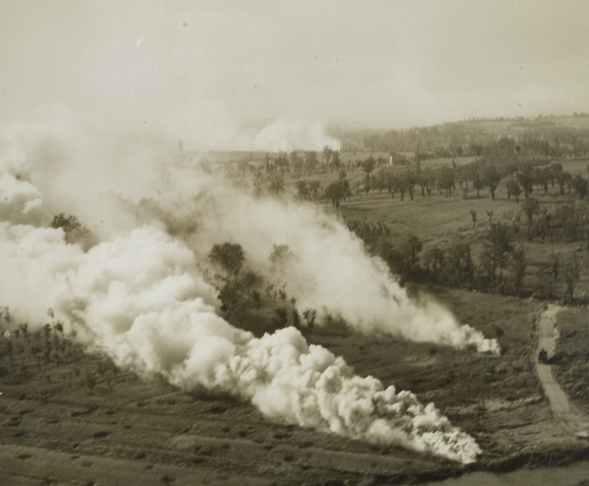 Where Rivers and Fighters Meet, 5/25/1944. ITALY—The junction of the Rapido, Liri, and Garigliano Rivers in Italy is screened by smoke pots after a bitter duel by German and Allied troops fighting in the area. With the opening of the new drive from the Anzio beachhead, the Allies are set for the final battle for Rome. Credit: ACME PHOTO BY CHARLES SEAWOOD, WAR POOL CORRESPONDENT.;