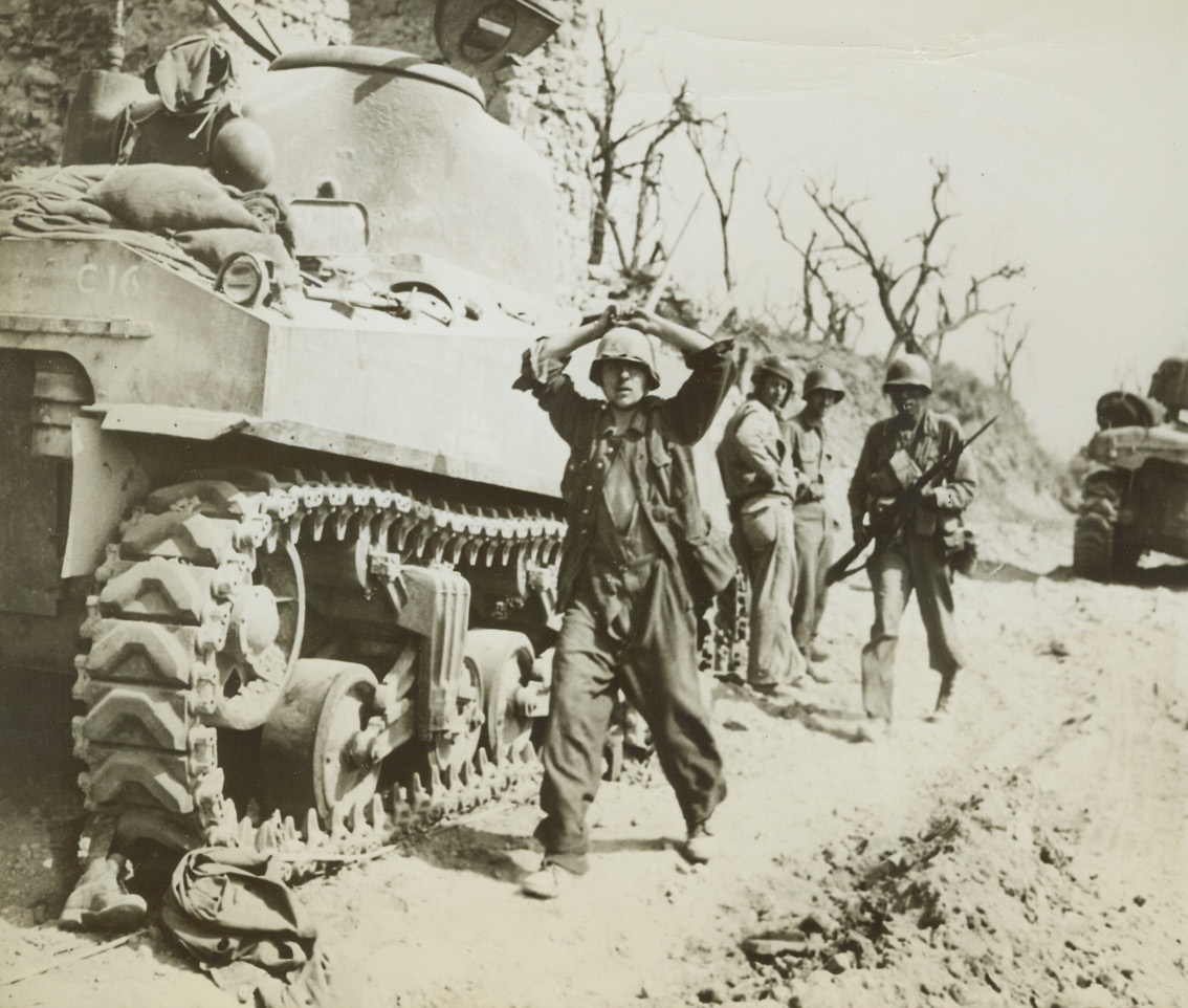 “SUPERMAN” FINDS CAPTURE EASY, 5/19/1944. ITALY—A german soldier, captured at Santa Maria Infante, Italy, is led to a detention camp behind the front lines. Americans took the town recently during the current Allied offensive and have already moved forward to pierce the Hitler Line.Credit: Acme;