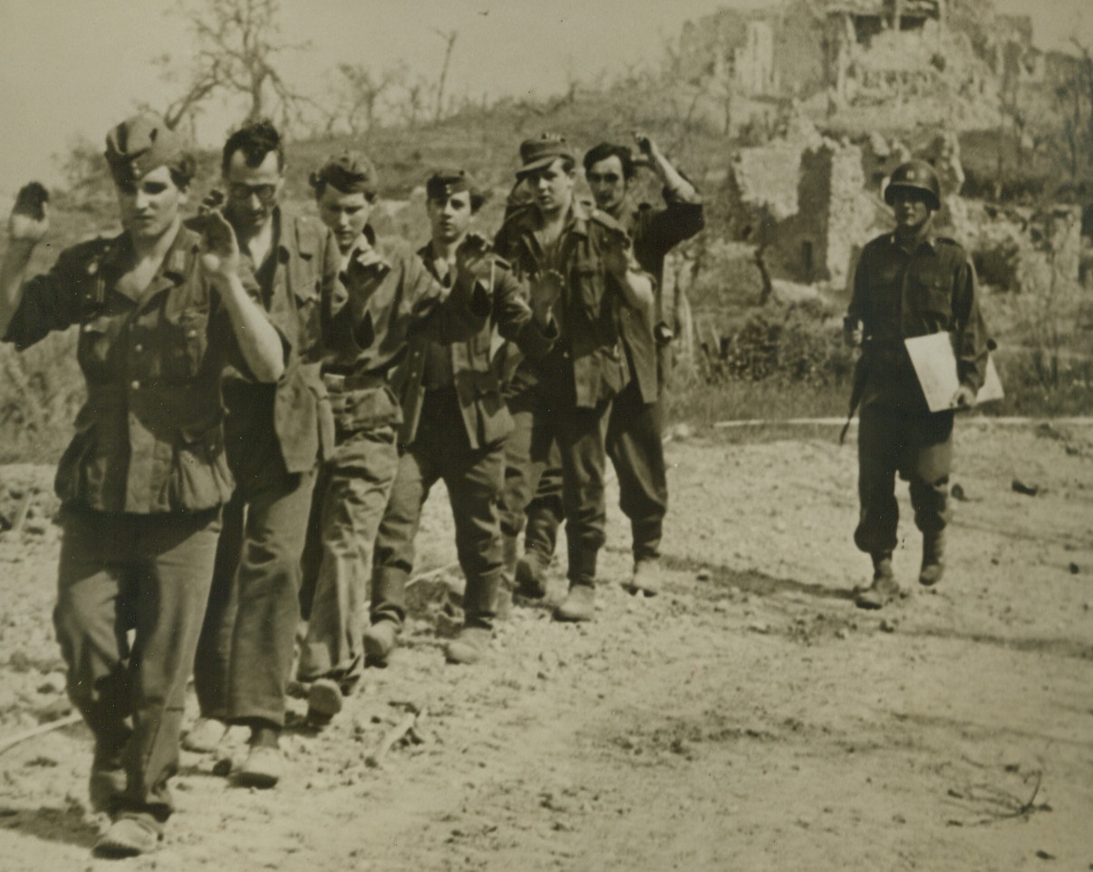 CAPTURED NAZIS IN ITALY, 5/19/1944. ITALY—An American captain of the Allied 5th Army leads a group of German prisoners to depots behind the front lines at Santa Maria Infante, Italy, where the enemy soldiers were captured. According to latest reports the Nazi retreat along the entire Italian front has approached the proportions of a rout.Credit: Acme;