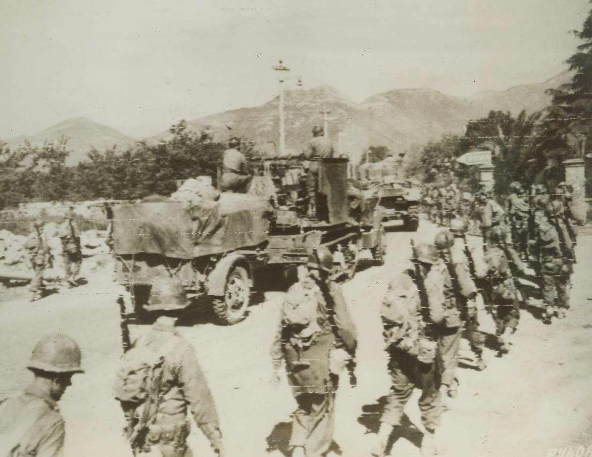 TO ROME!, 5/26/1944. ITALY—All signposts point to Rome, but our Allies full well know the way—they’ve been heading there for months. With the joining of the Anzio beachhead forces and the main front Fifth Army troops, the Allies are now marching swiftly toward the Alban Hills some fifteen miles southeast of Rome, where the Germans apparently hope to make their final stand for the Eternal City. Credit: US Army Radiotelephoto from Acme;