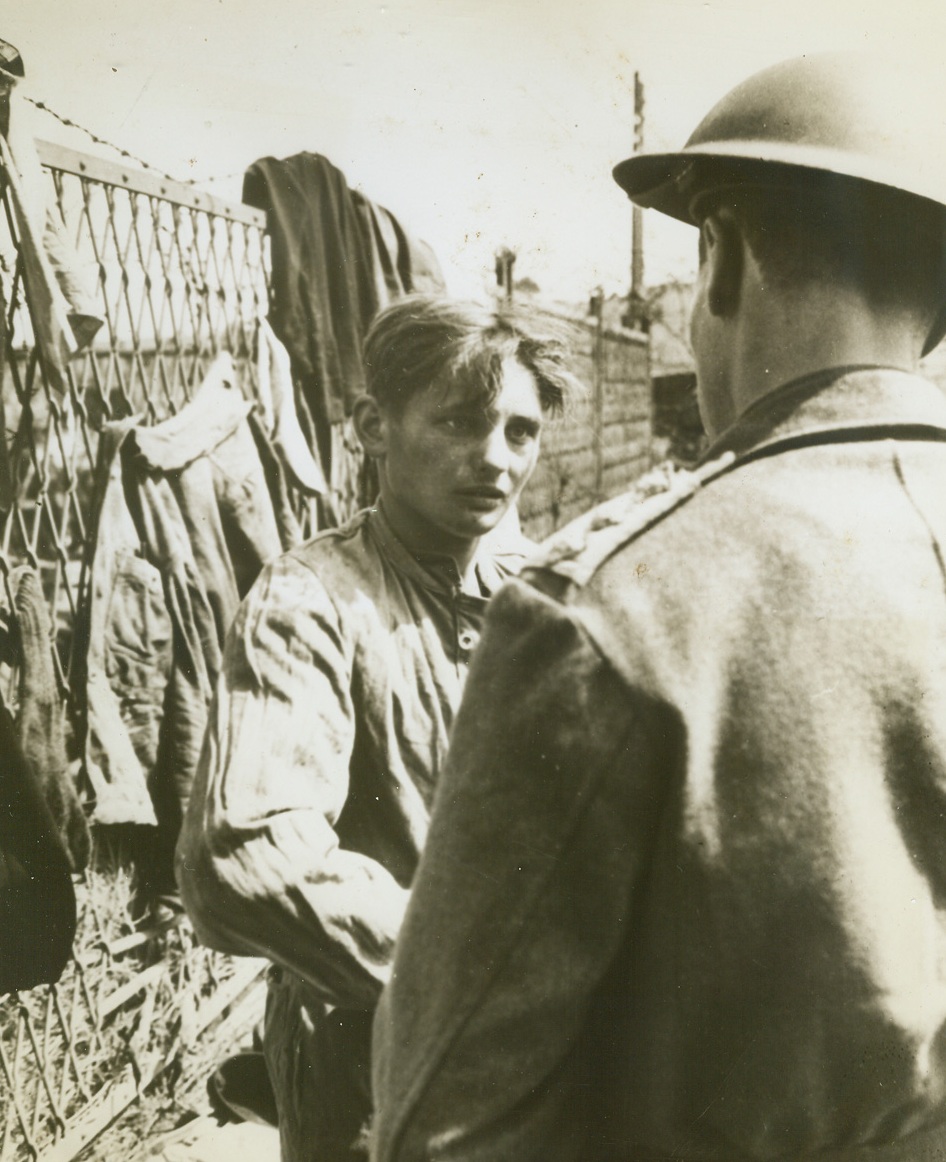 Captured Pilot of Nazi One-Man Sub, 5/31/1944. ITALY -- This 17-year-old German lad, (left), looks frightened and very unhappy as he is questioned by a British captain after his capture in a Nazi one-man submarine at Peter Beach in the Anzio beachhead area. The sub consisted of a driving tube which housed the pilot, and a detachable torpedo slung underneath. As the pilot reached his objective, he released the lethal charge and then piloted the driving tube to safety. Credit Line (U.S. Army Photo from ACME);