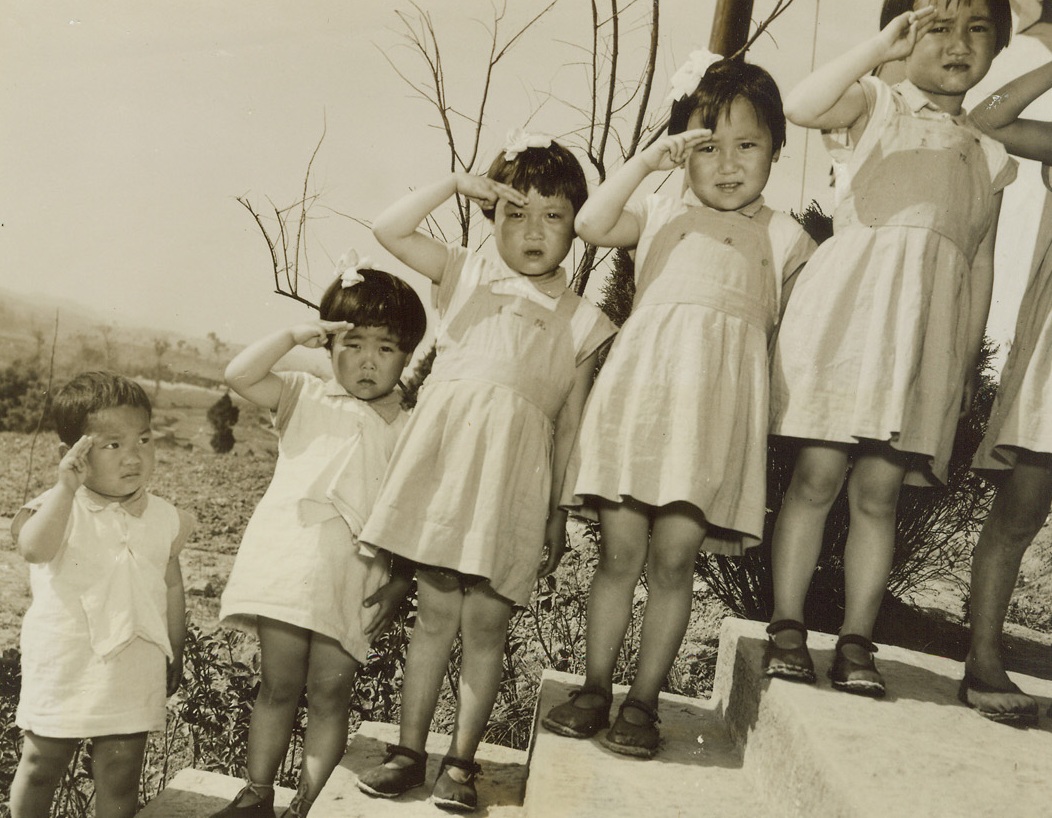 China’s Orphans, 5/18/1944. Chungking, China – Orphaned by the war that lays waste to their native land, these Chinese youngsters are learning to forget the terror that marked their early childhood at a new home for war orphans, near Chungking. Raising their hands to their foreheads, the youngsters salute Madame Chiang Kai-Shek as she visits their new home for opening day ceremonies on May 2nd.Credit: ACME photo by Frank Cancellare for the War Picture Pool;