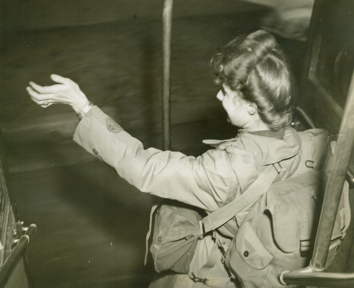 Texas WAC Rides to Australian Barracks, 5/24/1944. WAC Pvt. Woody R. Johnson, of Littlefield, Texas, a member of the first contingent of WACs to arrive in Australia, waves from the rear platform of a bus which transported the WACs from their ship to barracks in Sydney.;