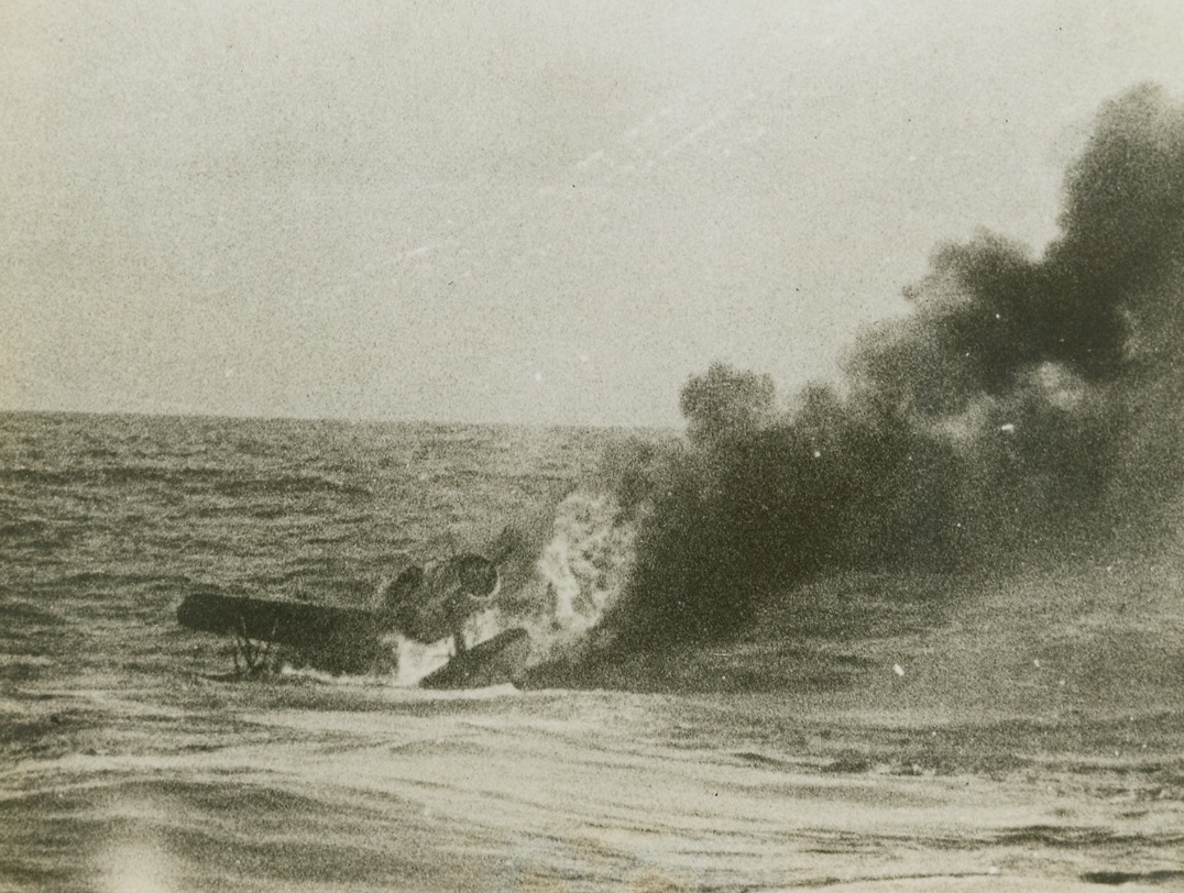 Sub Makes Daring Rescue off Truk, 5/20/1944. Truk – After the nine downed fliers clinging to this Kingfisher observation plane were rescued by the Navy sub “Tang”, the damaged plane was sunk by gunfire from the sub, and went to a watery grave, enveloped by flames.  During the heavy allied attack on Truk, April 29-30, the submarine rescued a total of 22 downed fliers and brought them back to Pearl Harbor. Credit (US Navy photo from ACME;