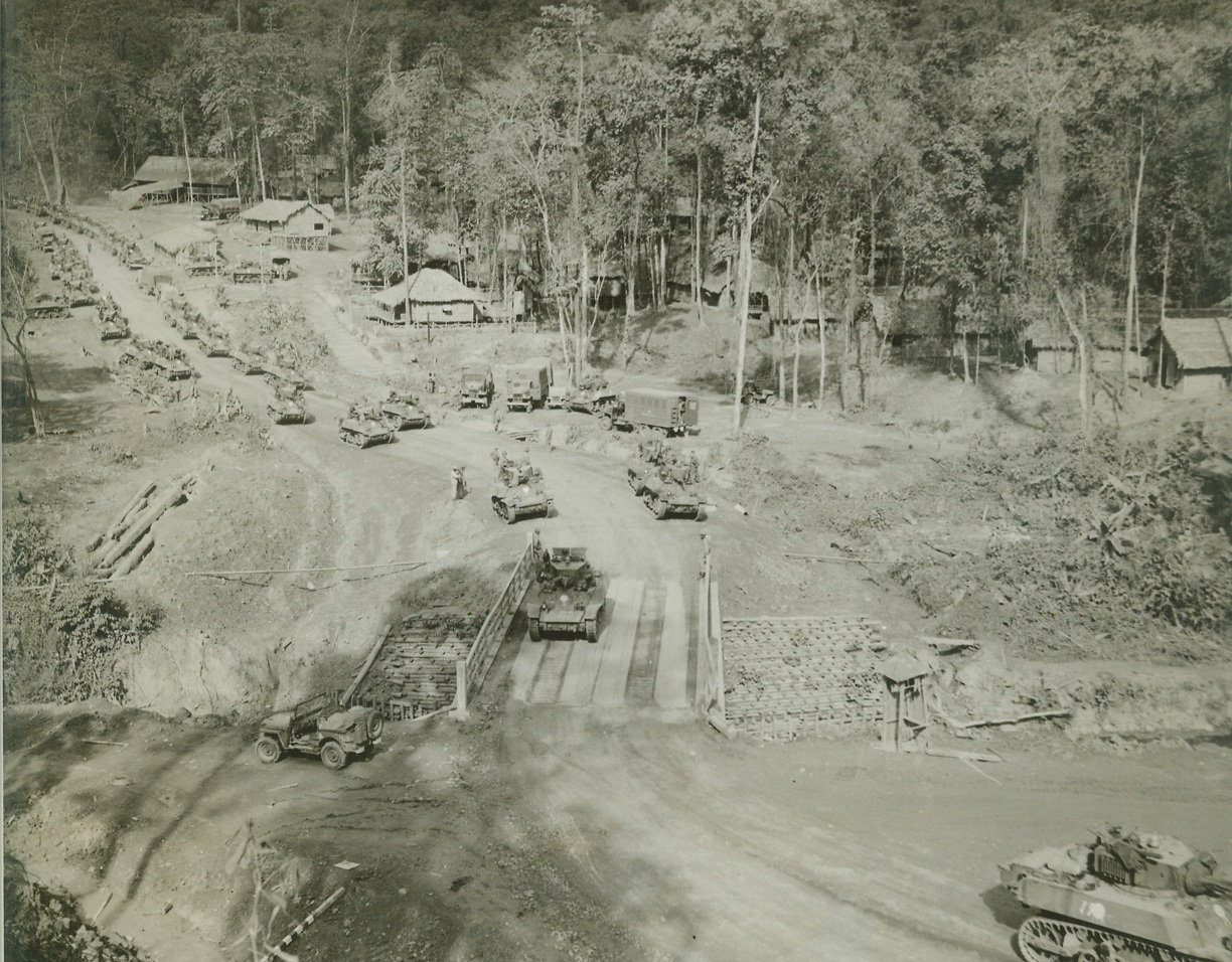 Yank Tanks Make Debut in Burma, 5/20/1944. Burma – To the American and Chinese jungle fighter troops in Burma have been added new mechanized units – American tanks now being used in the Hukawng Valley, the tanks have played a prominent part in driving back the Jap forces with resultant allied gains.  The Chinese soldiers who man the battle-wagons have been trained by Americans and  are fully equipped to use their vehicles to the best advantage.  The tanks reached the battle area in Hukawng valley by traveling over the newly-constructed Ledo road, from Assam. To the valley the following pictures show the tanks in use in their new territory. New York Bureau Emerging from the hills around Assam, the tanks wind down the Ledo road en route to the battle front.  The thatched huts are evidently part of a behind-the-lines Army camp. Credit (ACME photo by Frank Cancellare, War Pool correspondent);