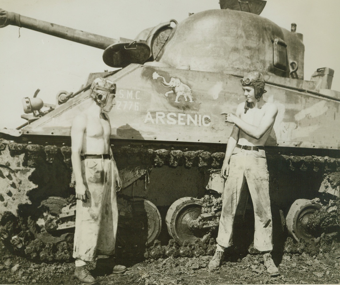-- But, No “Old Lace”!, 5/18/1944. South Pacific – A bitter dose to the Japs in the South Pacific, is this U.S. Marine Corps tank, appropriately dubbed “Arsenic”.  Two of the battle-hardened crew members stand beside their “Nip Eliminator.”  Left to right, are: Cpl. Rocky J. Bonoma, son of Mrs. Ida Bonoma, 6258 Cuyler Ave., Chicago, Ill.; and Sgt. Paul E. Wyers, son of Mrs. Martha Wyers, 410 Weatherly St., Borger, Texas. Credit line (U.S. Marine Corps photo from ACME);