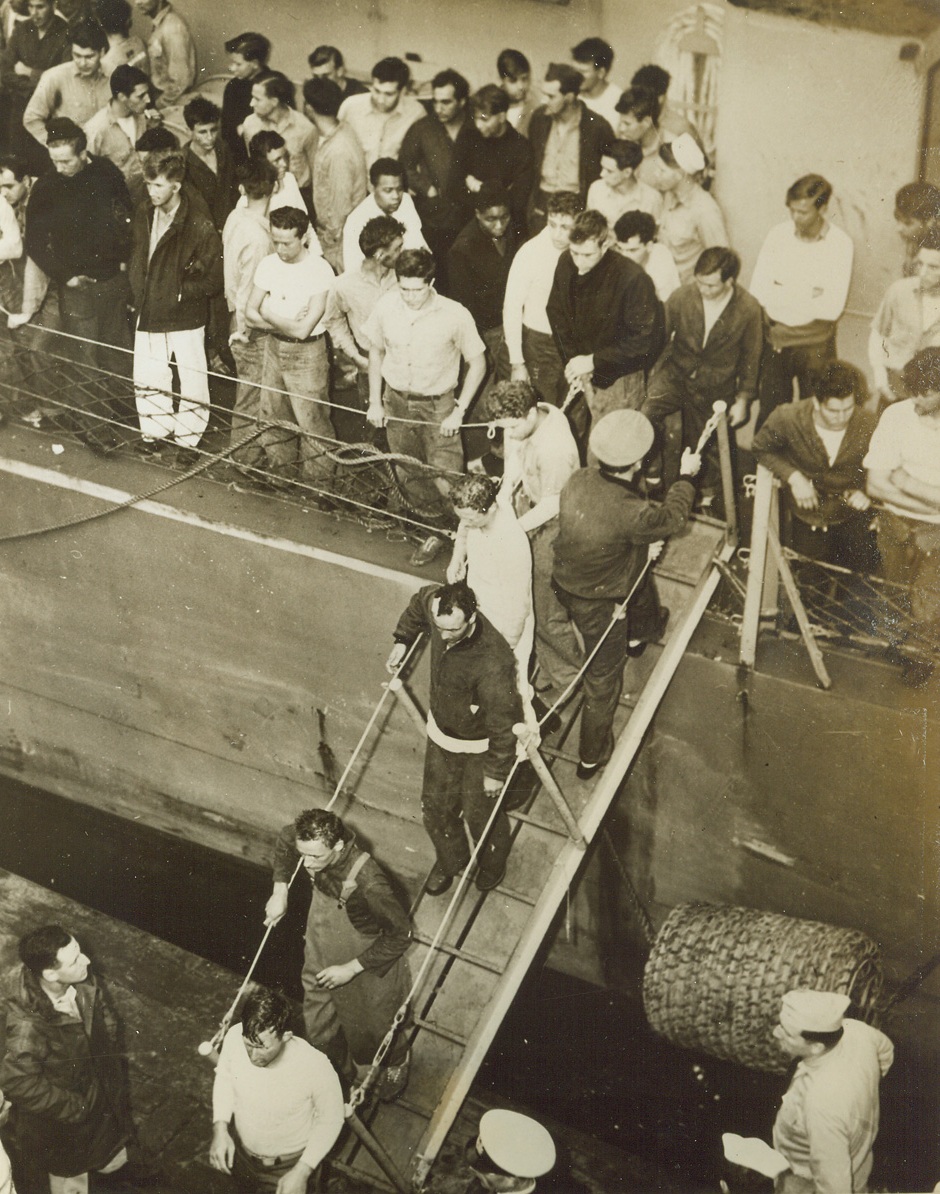 Escaped Death, 5/10/1944. North Africa – Lt. Robert Morgenthau, USNR, hands in pockets, extreme lower left, son of Secretary of Treasury Henry J. Morgenthau, Jr., was one of the many Americans rescued by two Coast Guard destroyer escorts after the destroyer Lansdale was bombed and sunk in a German attack off the coast of North Africa.  Morgenthau, executive officer of the vessel, watches Navy seamen descend the gangway after they had been carried safely to a North African port. Credit (US Coast Guard photo from ACME);