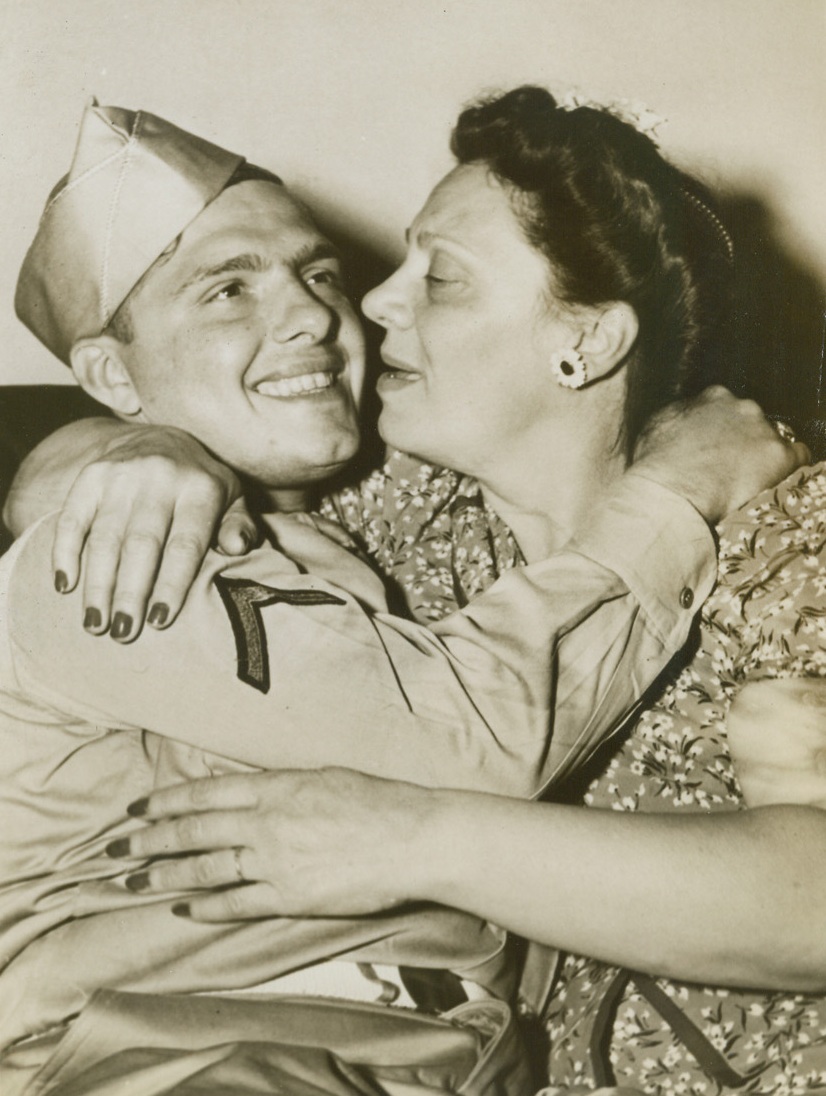 Joyous Reunion, 5/22/1944. Philadelphia, PA. - Mrs. Angelina De Lisio ardently embraces her son upon his return to his home in Philadelphia, Pa. He is Pfc. Edward De Lisio who fought in the North African Campaign and was listed as killed in action by the War Department for more than a month until the mistake was discovered. Credit: ACME;