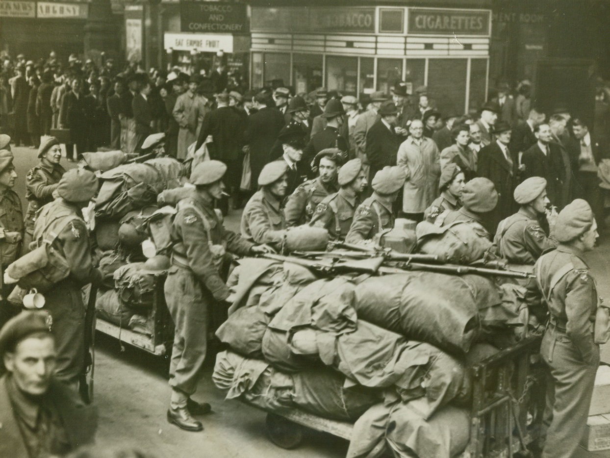OFF TO THE RACES!, 5/23/1944. LONDON, ENG. – Soldiers on a troop movement move aside to make way for the long line of civilians who crowd the Liverpool St. station en route to the races at New market.  War or no war, the English will never lose their inherent love of sports, and they flock to these classic races. Credit: Acme;