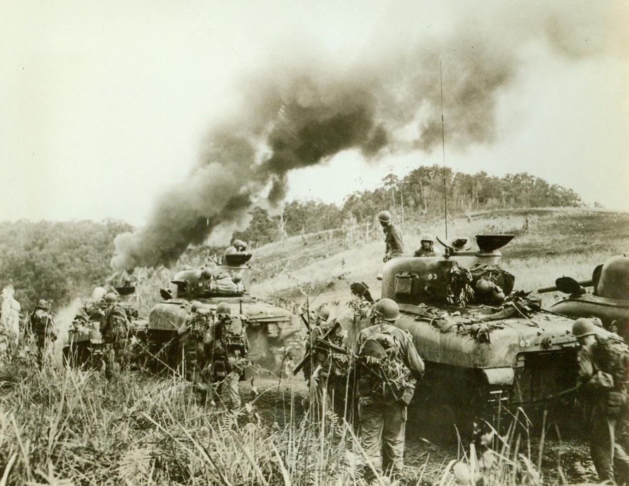 “Battle-Wagons” Carry Invading Allied Forces, 5/8/1944. Hollandia— Organizing these “General Sherman” tanks to set out in pursuit of Fleeing Japs, these Allied soldiers head in the direction of the heavy wooded areas around Hollandia. The invading forces struck a surprise blow at the Japs at Hollandia, and came out of the battle with one more important enemy airfield added to their roster of conquered enemy territory. These routine “mop-up” patrols are designed to crush and remaining Jap resistance. 5/8/44 (ACME);