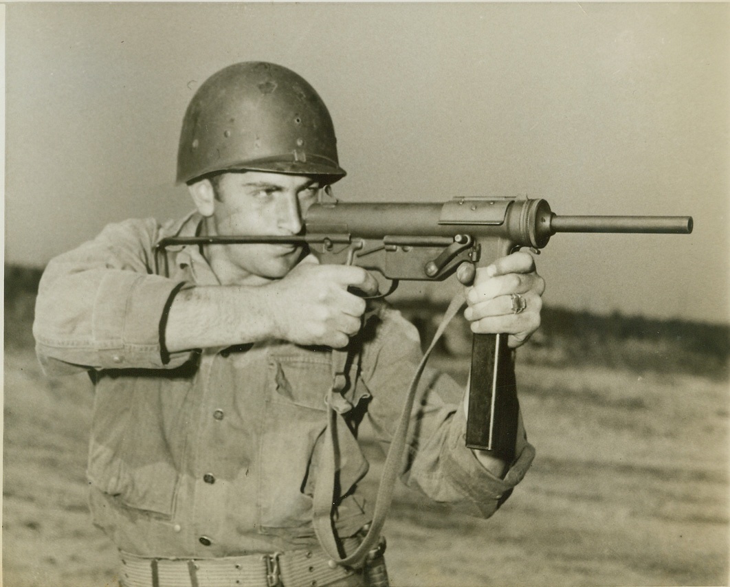 Lighter, Cheaper, and Just as Good, 5/6/1944. CAMP DAVIS, N.C. -- The deadly weapon being used by Pvt. Martin Schirald of Youngstown, Ohio, at Camp Davis is the Army's new .45 caliber sub machine gun -- the "M3". Five and one half pounds lighter than the widely used Thompson sub machine gun, the new weapon is much cheaper to manufacture and just as effective in battle. Credit: (ACME);