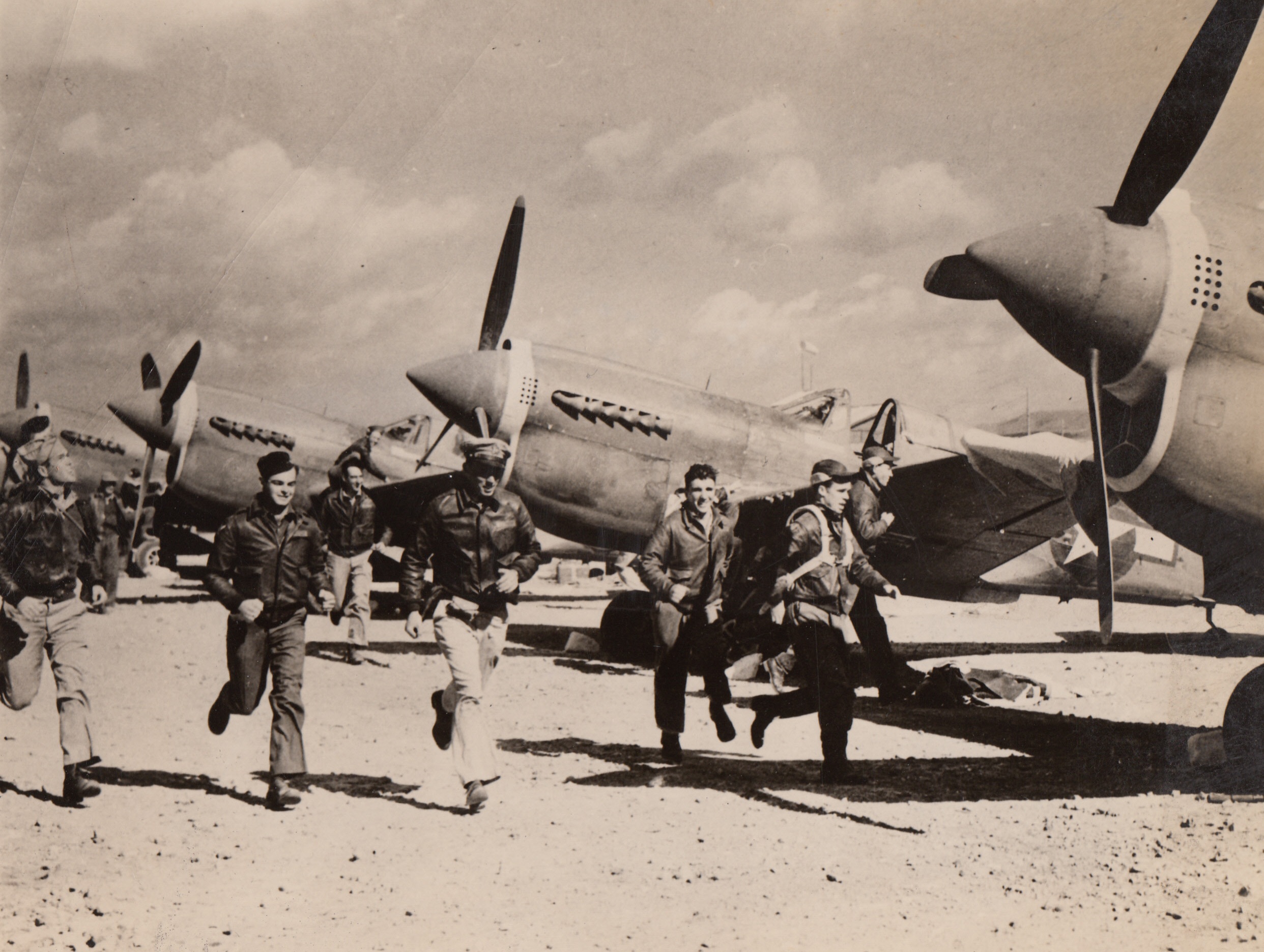 “Jing Bow! – Jing Bow!”, 5/9/1944. Somewhere in China – Here is a typical scene at a U.S. 14th Air Force base somewhere in China. As the cry “Jing Bow!” (Air raid in Chinese) echoes through the area. As soon as the signal is given “Flying Tiger” pilots hurry toward their planes, ready to go up after the enemy raiders. 5/9/44 Credit Line (Official U.S. Army Photo From ACME);