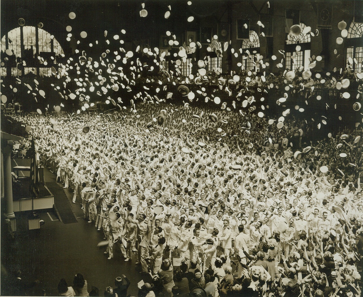 FUTURE ADMIRALS FOLLOW TRADITION, 6/7/1944. ANNAPOLIS, MD – The largest class of midshipmen in the history of the United States Naval Academy graduated June 7th. Following tradition, their hats fly into the air as they cheer following the distribution of diplomas. Credit: ACME;