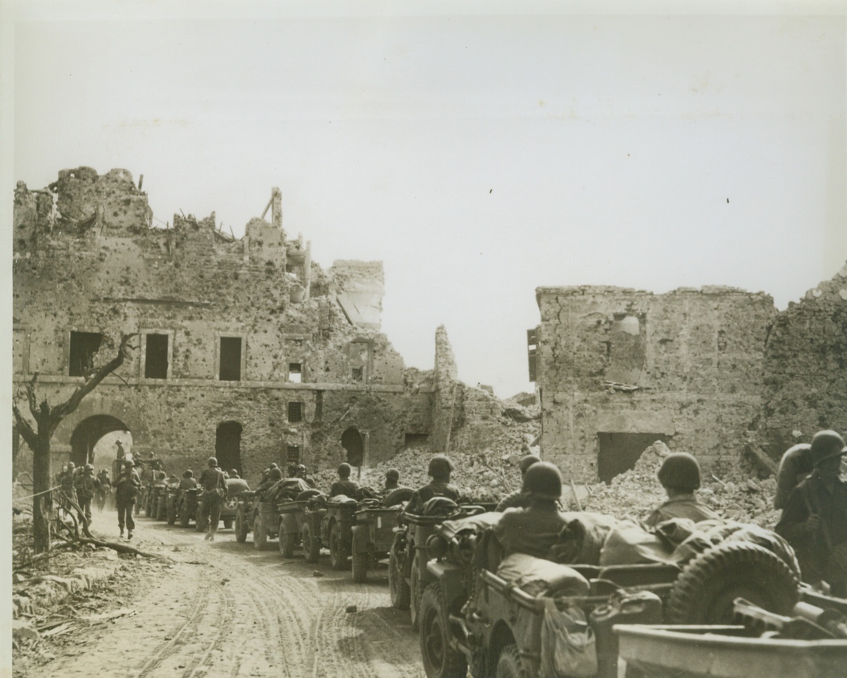 Parade of Jeeps through Cisterna Castle, 6/9/1944. Italy – A long line of Jeeps, American cavalry, winds through the ruins of what was once a proud castle in Cisterna, Italy. Troops are in pursuit of the Germans who had used the castle for a fortress. This town was taken by Anzio forces of the Allied Fifth Army in the early stages of the drive on Rome. Credit-WP-(ACME);