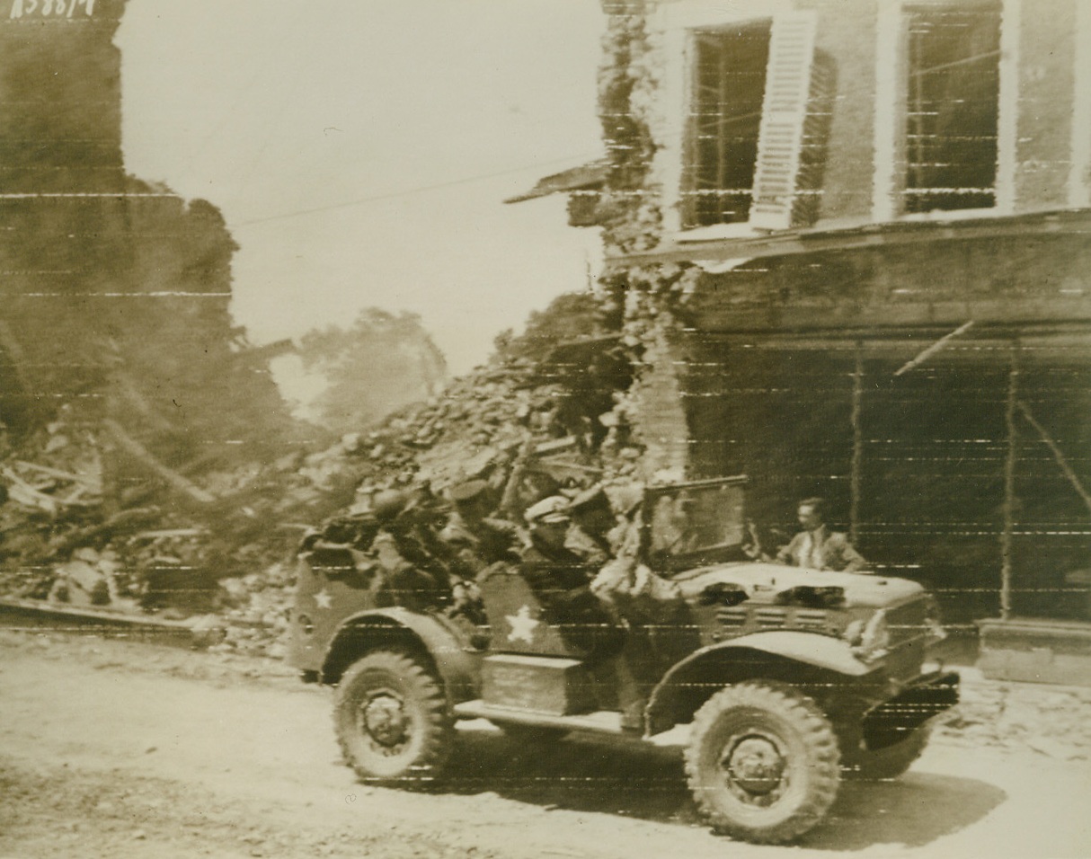 U.S. Chiefs inspect Invasion Beachhead, 6/13/1944. FRANCE—This Photo, flashed to the U. S. by Radiotelephoto today, shows American Army and Navy chiefs as they ride through a ruined town on the Allied Beachhead in France on a tour of inspection.  In the combat car are Gen. George C. Marshall, U.S. Army Chief of Staff; Gen. Dwight D. Eisenhower, USA Supreme Allied Commander in Europe; Admiral Earnest J. King, admiral of the US Fleet; and Gen. Henrey H. Arnold Chief of the USAAF. Passed by censors. Credit:  U.S. Signal Corps Radiotelephoto;