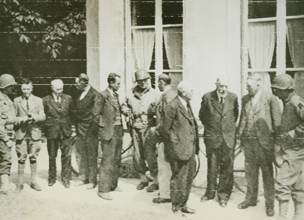 French Mayors Discuss Food, 6/21/1944. In this photo, flashed to the U.S. today by radiotelephoto, the mayors of six liberated towns in France as they met to discuss problems of food storage and distribution with officials of the Allied military government. Credit: Army radiotelephoto from ACME.;