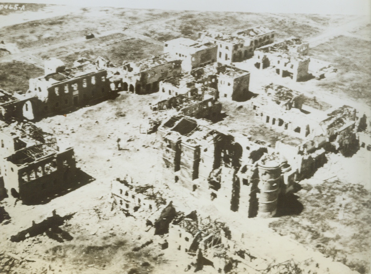 The Scars of Battle are Vivid, 6/2/1944. ITALY—Only gutted buildings remain in the Aprilla, Italy “factory” area where bitter fighting raged between the Allies and the Germans. An unforgettable landmark to the beachhead forces, this photo of the settlement was made from an observation plane. Credit: U.S. ARMY RADIOTELEPHOTO FROM ACME.;