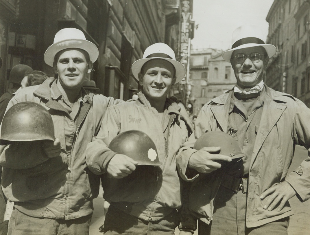 SPRING HATS FOR G.I.’S, 6/13/1944. ROME, ITALY—Carting their tin helmets in true Gay Nineties style, Pfc. Albert Roblewski, Bronx, N.Y. (left); Pfc. Rudy Valek, Allentown, Pa. (center); and Cpl. Philip Smith, York, Pa. don the summer Panama hats they bought in Rome. Very nice, boys, but what would your C.O. say?Credit: Acme photo by Charles Seawood, War Pool Correspondent;