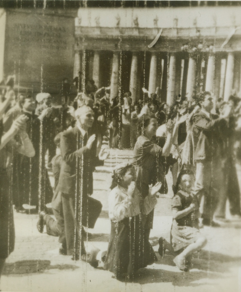 /ROMANS GIVE THANKS FOR LIBERATION, 6/7/1944. ROME—Hands clasped in prayer, these Romans give thanks for their liberation from Nazi overlords. They are crowded in St. Peter’s Square awaiting the Pope’s appearance to lead them in their thanksgiving. Credit: OWI Radiophoto from Acme;