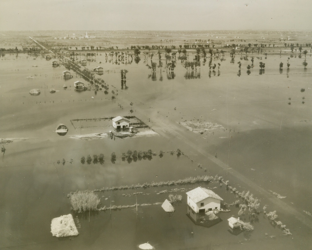 Where Fifth Army Marched Through Italy, 6/2/1944. ITALY -- Taken by Charles Seawood, Acme Newspictures War Pool Correspondent, these pictures show some of the towns, former battlefields, through which the Fifth Army has marched and fought in the current offensive in Italy. The Pontine Marshes, flooded by the Germans in an attempt to impede the Allied march, are also seen in photos which were taken from an artillery observation plane. New York Bureau The Pontine Marshes, flooded by the enemy in an attempt to impede the Allied offensive, stretch to the horizon in this photo. Partially submerged Italian farms dot the line where a road once was. This photo is the original of a radiophoto previously serviced. Credit - WP - (ACME Photo by Charles Seawood, War Pool Correspondent);