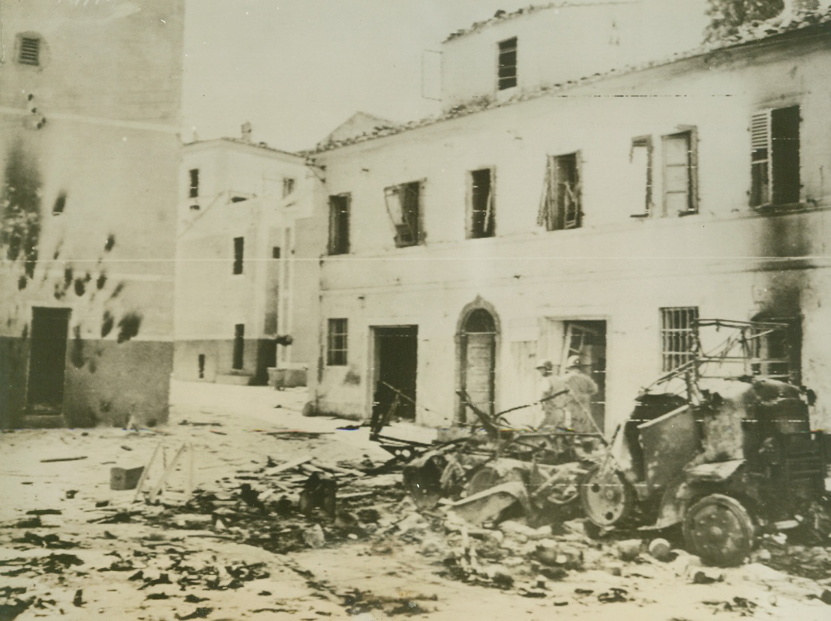 THE WAR REACHES ELBA, 6/20/1944. WASHINGTON, D.C.—Wrecked German vehicle attests to the destruction wrought by Naval rocket barrages in the town of Marina Di Campo, in Elba. 1,800 enemy troops were captured by French Colonials in the downfall of the island. Credit: Signal Corps Radio-Telephoto from Algiers via Acme;
