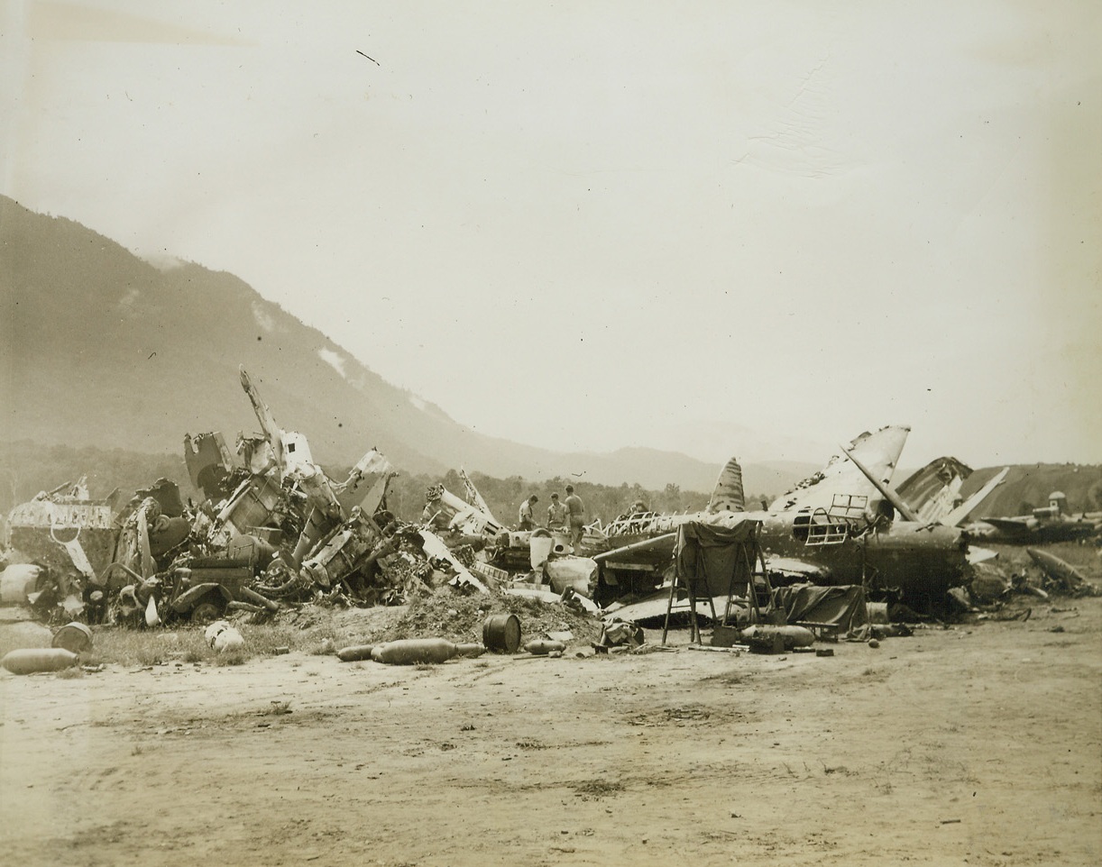 Warbird Boneyard, 6/12/1944. Hollandia – All that remains of Jap warbirds that were shot up on Hollandia Airstrip during Allied raids in the battle for the strategic filed is piled high in this corner of the strip. Allied fighters swept the wreckage of the planes to one side so that our forces might begin using the airfield immediately after its capture. Credit: ACME photo by Frank Prist, Jr. for the War Picture Pool;