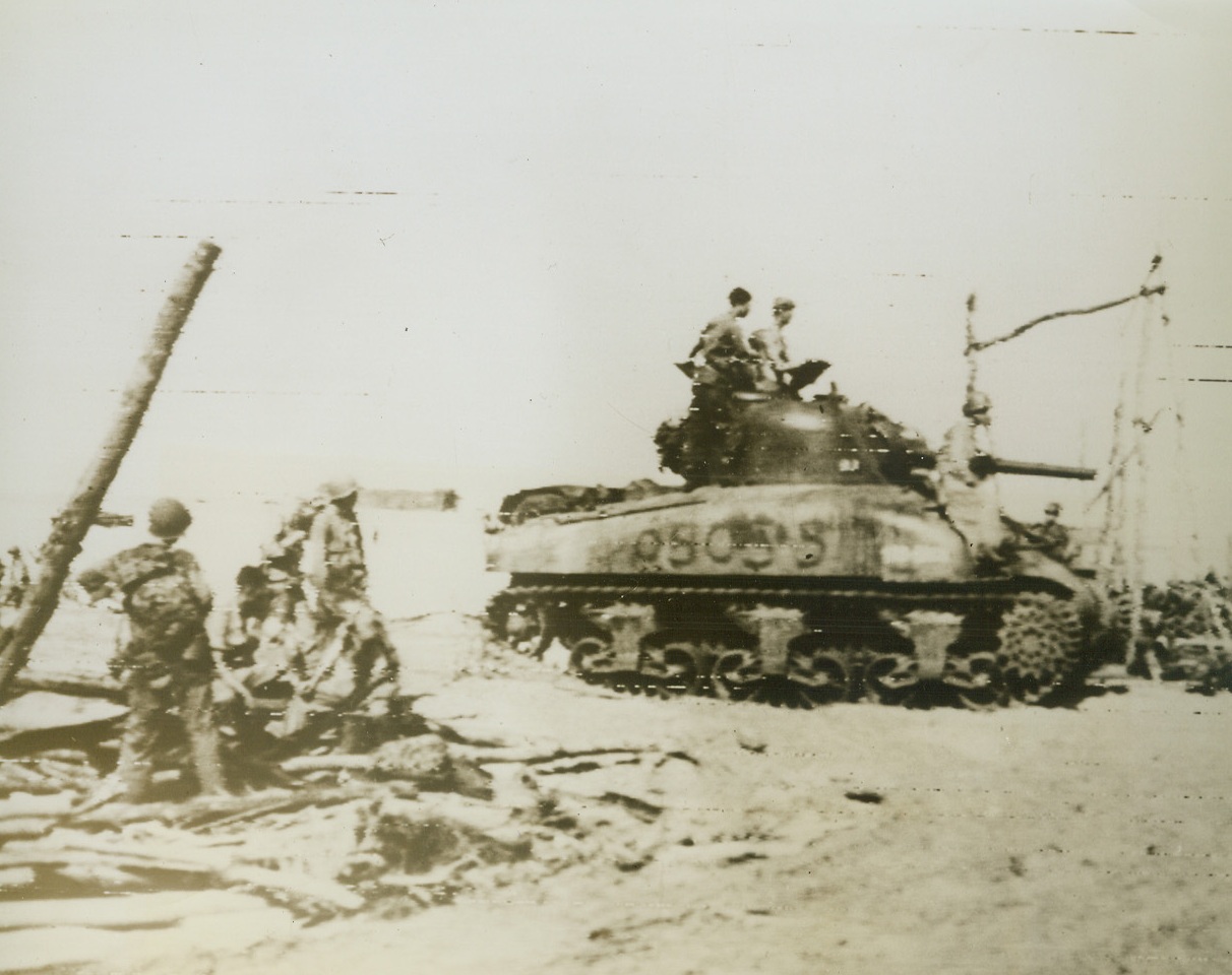 Jap Hunting at Biak, 6/3/1944. South Pacific – United States Medium Tanks move ashore at Biak Island in the Schouten group. Shortly after their arrival the American tanks engaged several Japanese Tanks in the first battle of its kind in the Southwest Pacific. Even in the treacherous jungle terrain the American vehicles proved superior to the enemy’s. Credit: US Army Radiotelephoto from ACME;