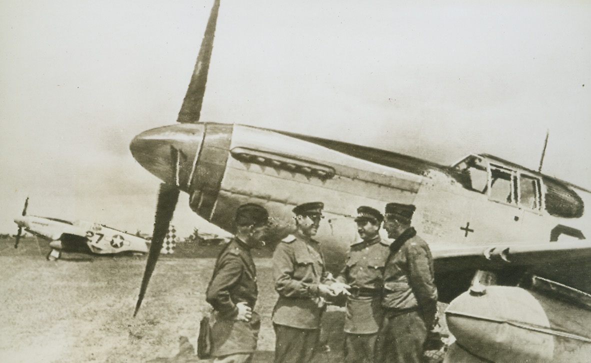 Yank Airfield in Russia, 6/7/1944. Russia – With the disclosure that after bombing enemy military targets in Romania, American “Flying Fortresses” had landed on an aerodrome in the Soviet Union, the potentialities of shuttle bombing become even more potent than they already are. A group of Yank airmen are shown gathered around the field kitchen at an American airfield in Russia. Credit: ACME Radiophoto;