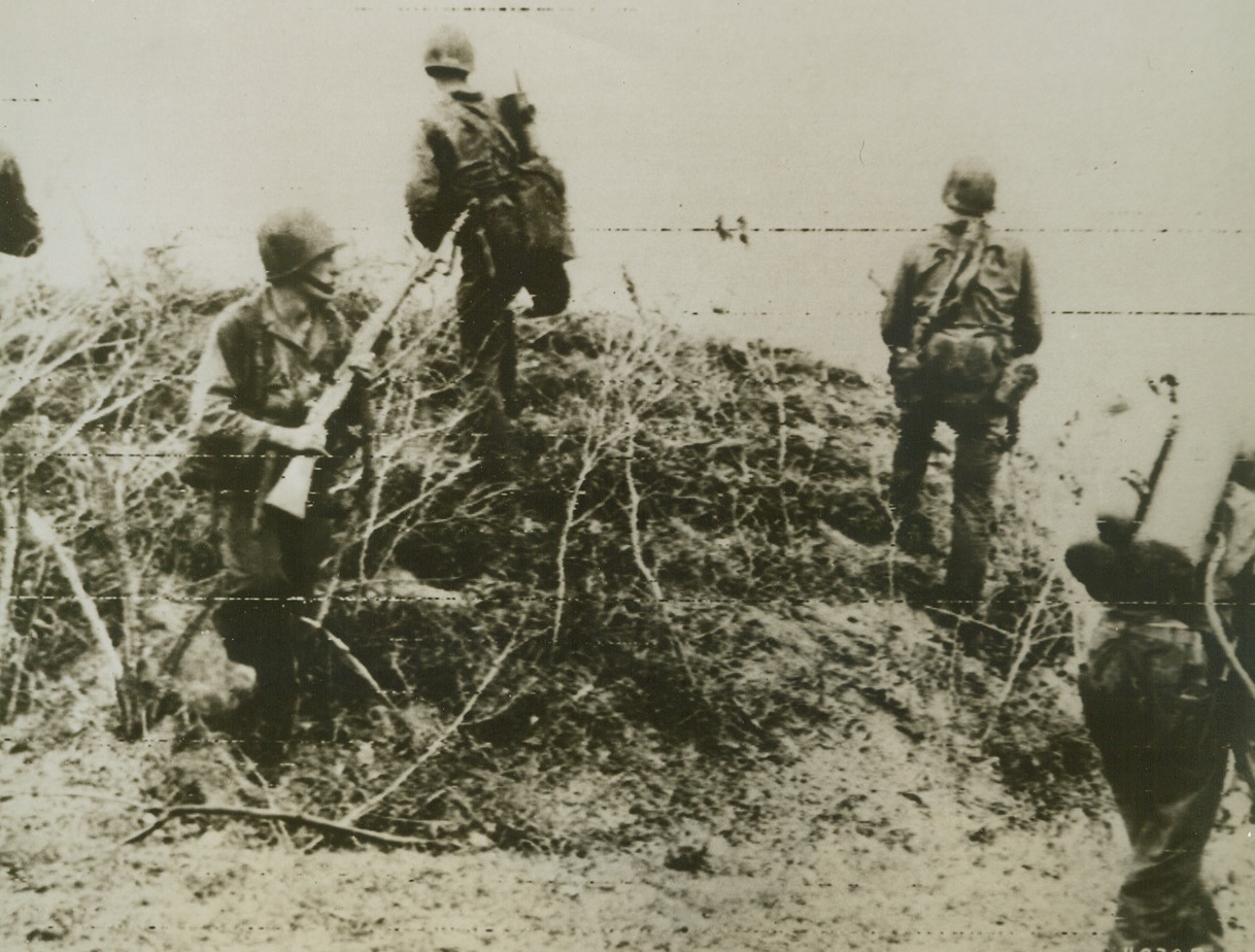 Making It Hot for the Japs, 6/24/1944. Saipan – Using the fearsome flamethrower, U.S. Army Infantrymen destroy a Jap pillbox position. Yank troops march steadily through the strongly defended island meeting stiff resistance in most cases but today, in reaching the capital city of the Japanese Marianas, American patrols met almost no opposition. Credit: Signal Corps Radiotelephoto from ACME;