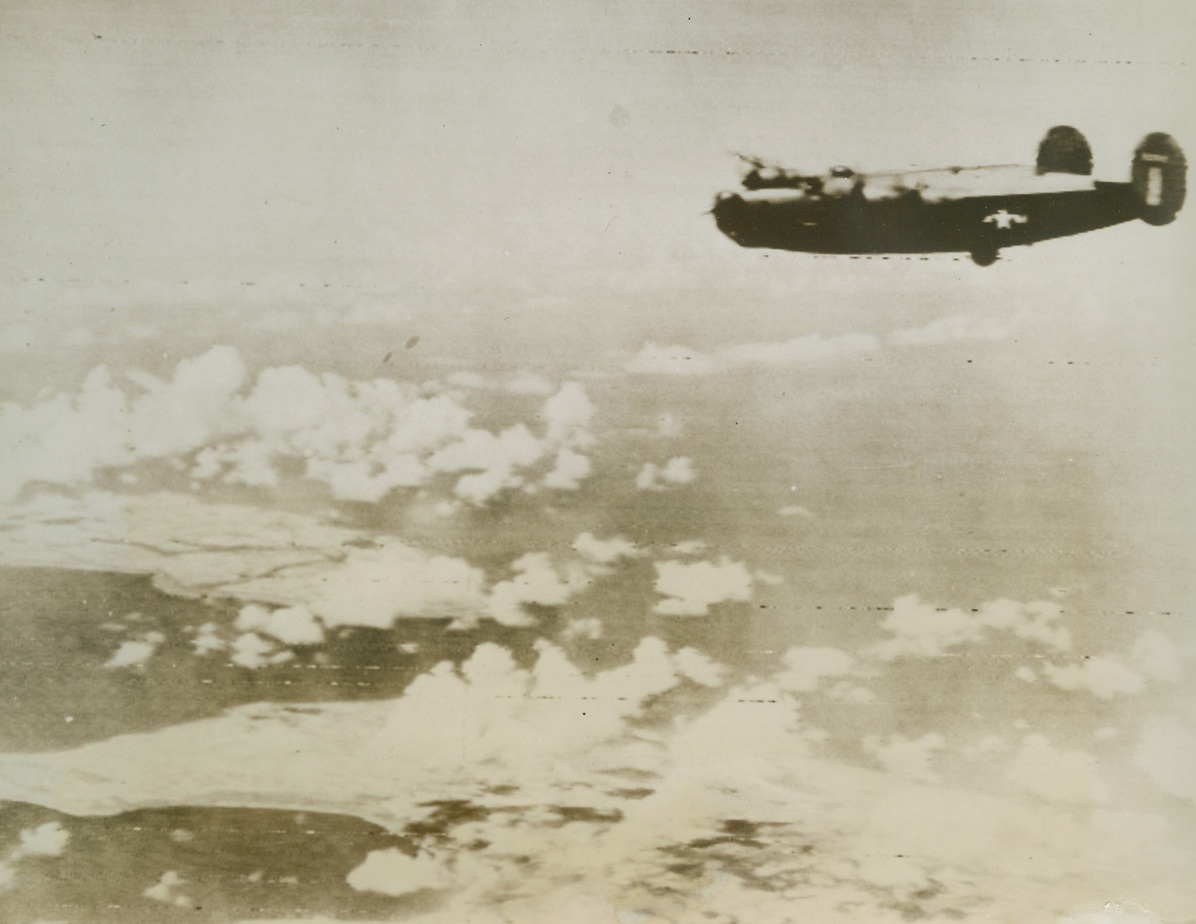 Blast Jap Bases in Marianas, 6/16/1944. Pacific – A bomber of the 7th Air Force flies over a group of islands, Jap strongholds, in the Marianas on its mission of destruction. Softening-up attacks on the island group preceded the invasion by American troops of Saipan yesterday. Credit (Signal Corps Radio telephoto from ACME);