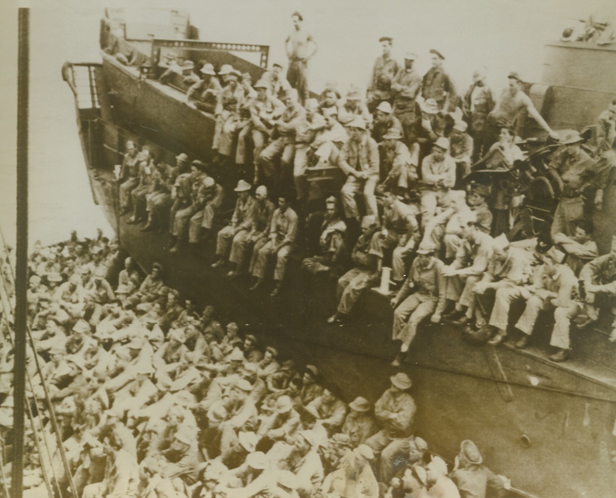 Invasion Briefing, 6/18/1944. At Sea – en route to the Marianas for the invasion of Saipan, where fierce fighting is now in progress, soldiers listen to instructions given them aboard a combat transport.  Photo was flashed to the U.S. from Hawaii. Credit (Signal Corps radio telephoto from ACME);
