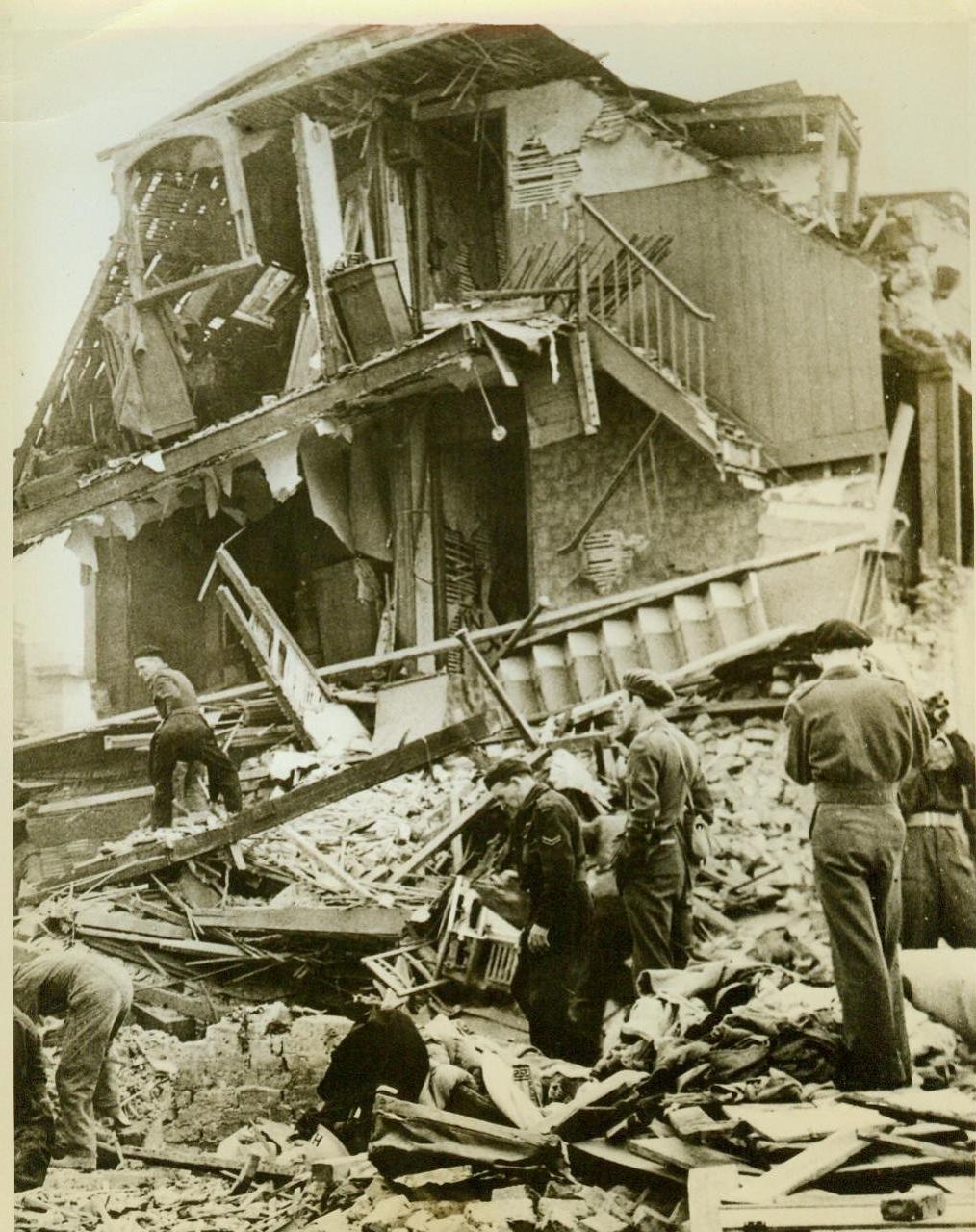 Hunt for victims of robot planes, 6/19/1944. SOUTHERN ENGLAND – Combing the ruins of a home in southern England, rescue workers hunt for possible victims of a raid by the Nazi pilotless plane. The demon ship, sent across the Channel from one of the few robot launching platforms still left after Allied bombings, left this scene of destruction in its wake. CREDIT LINE (ACME) 6/19/44;